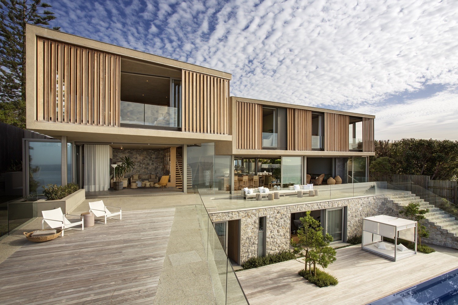 Modern house with wooden louvers and stone facade HD Wallpaper