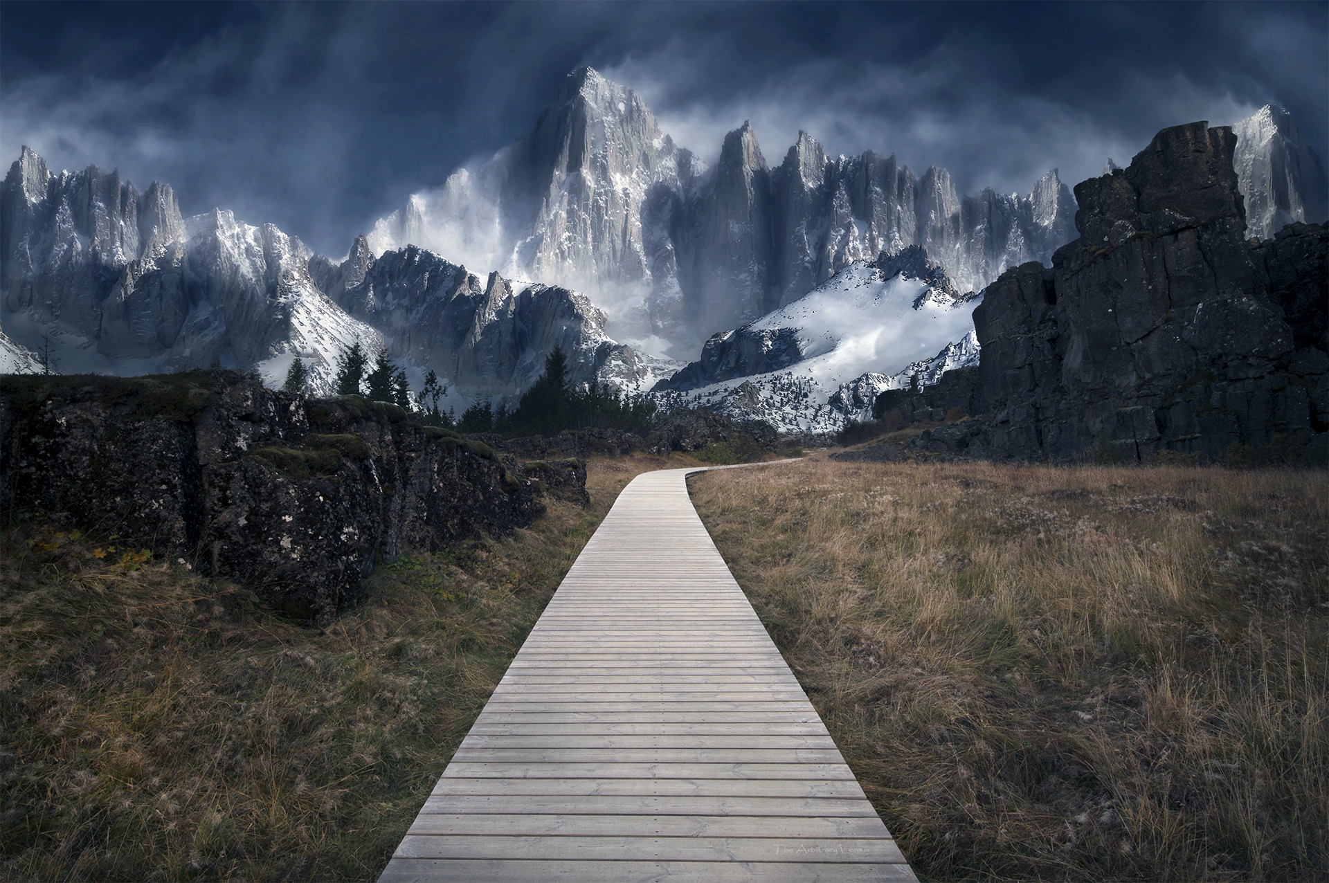 Wooden path leading to snow-capped mountains under a cloudy sky HD Wallpaper