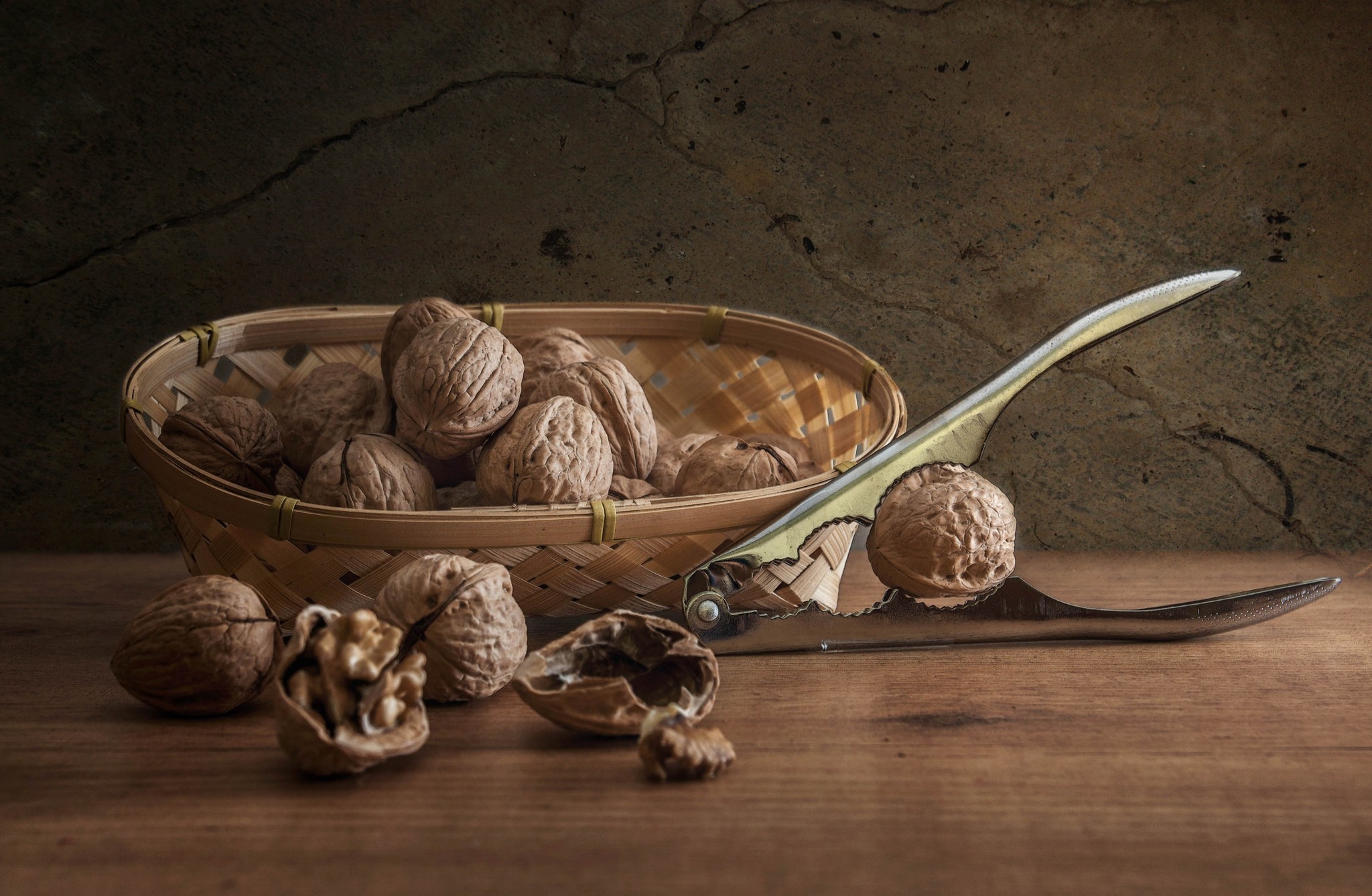 Walnuts in a basket with a nutcracker HD Wallpaper