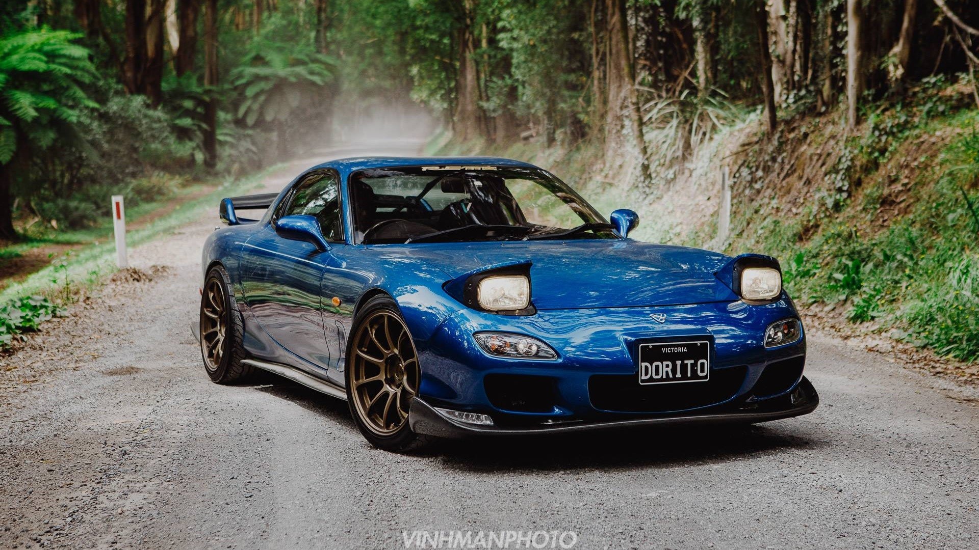 Blue Mazda RX-7 FD with pop-up headlights on a dirt road HD Wallpaper
