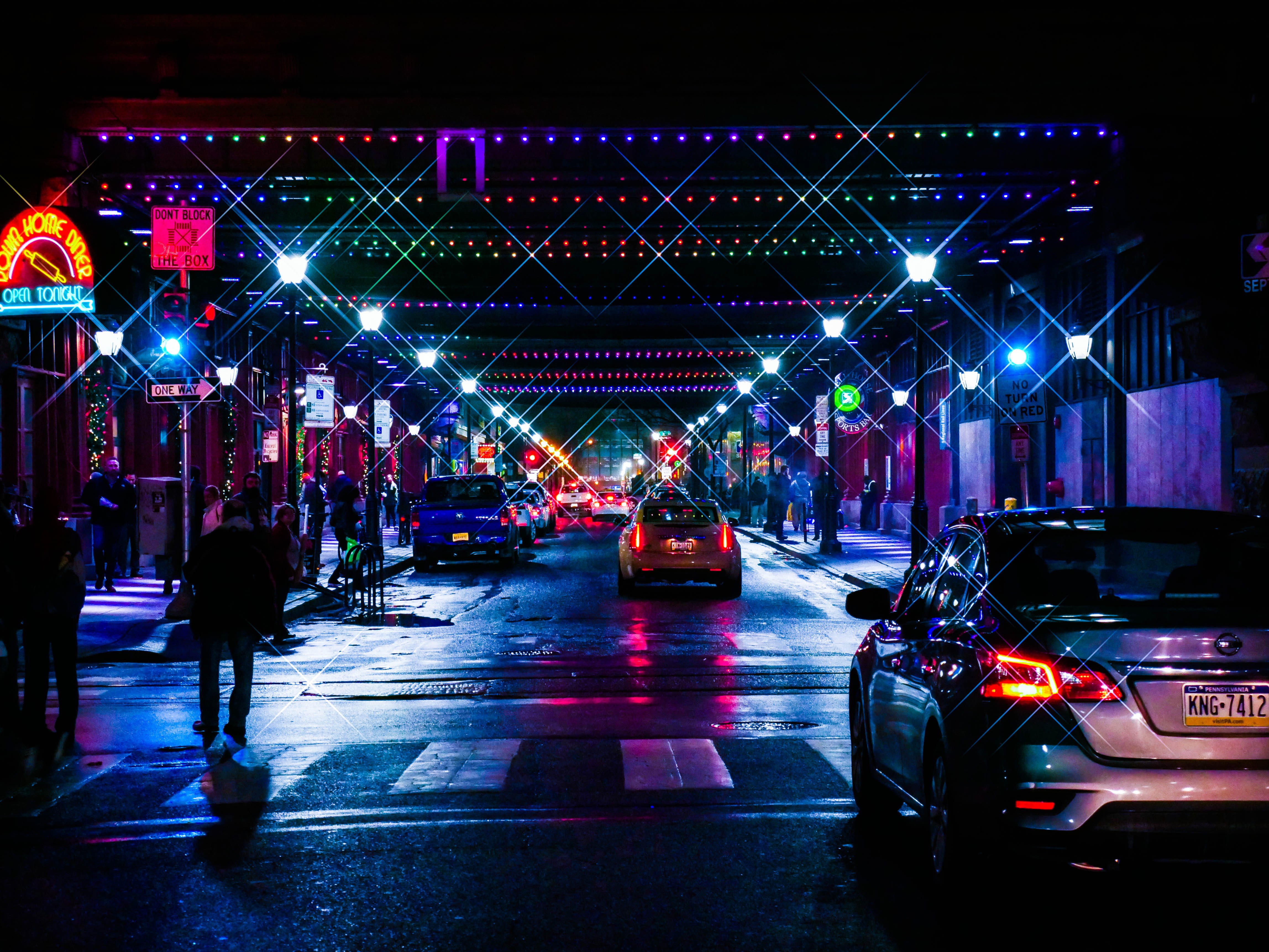 Night street with neon lights and cars in Pennsylvania HD Wallpaper