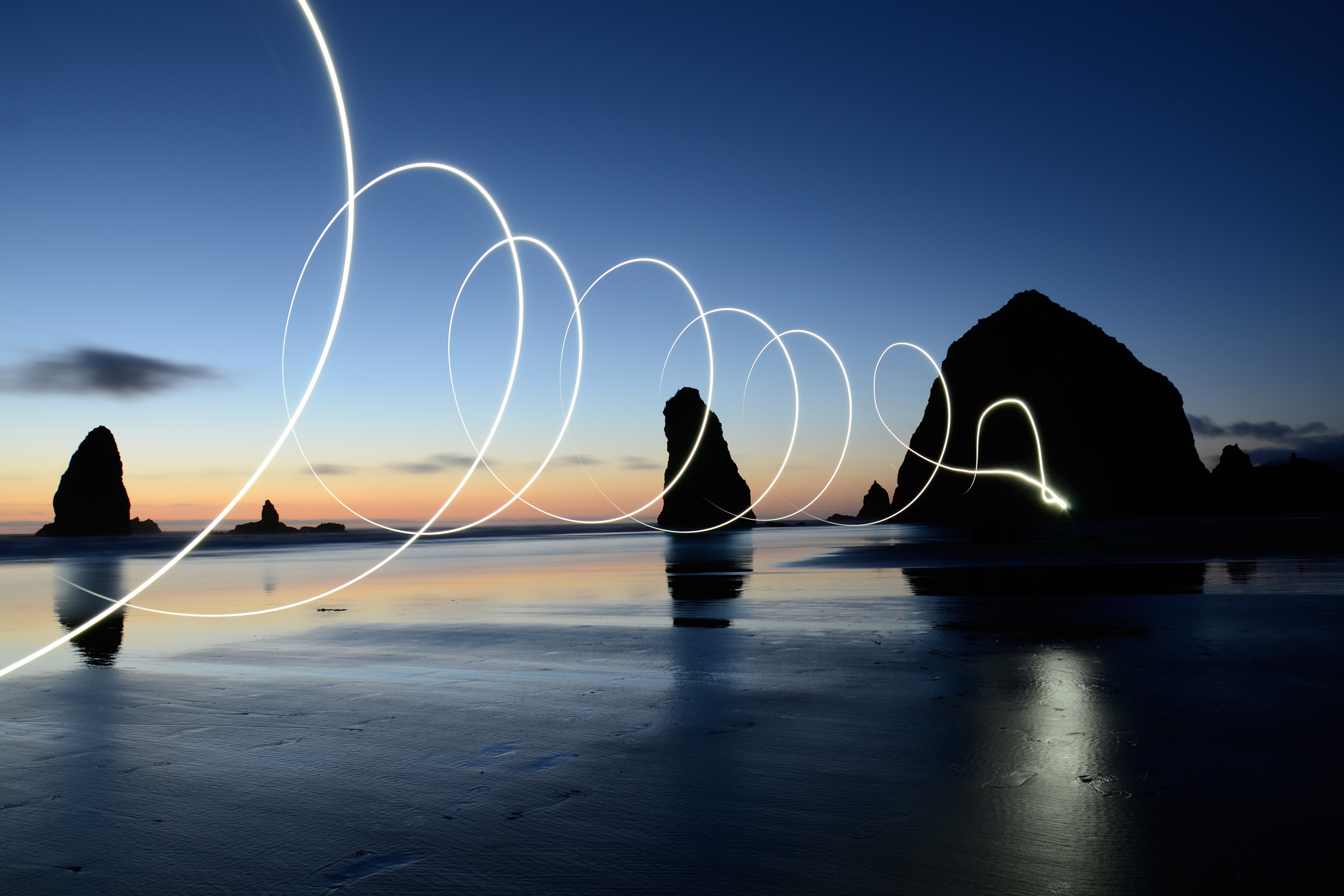 Light painting on a beach at dusk HD Wallpaper