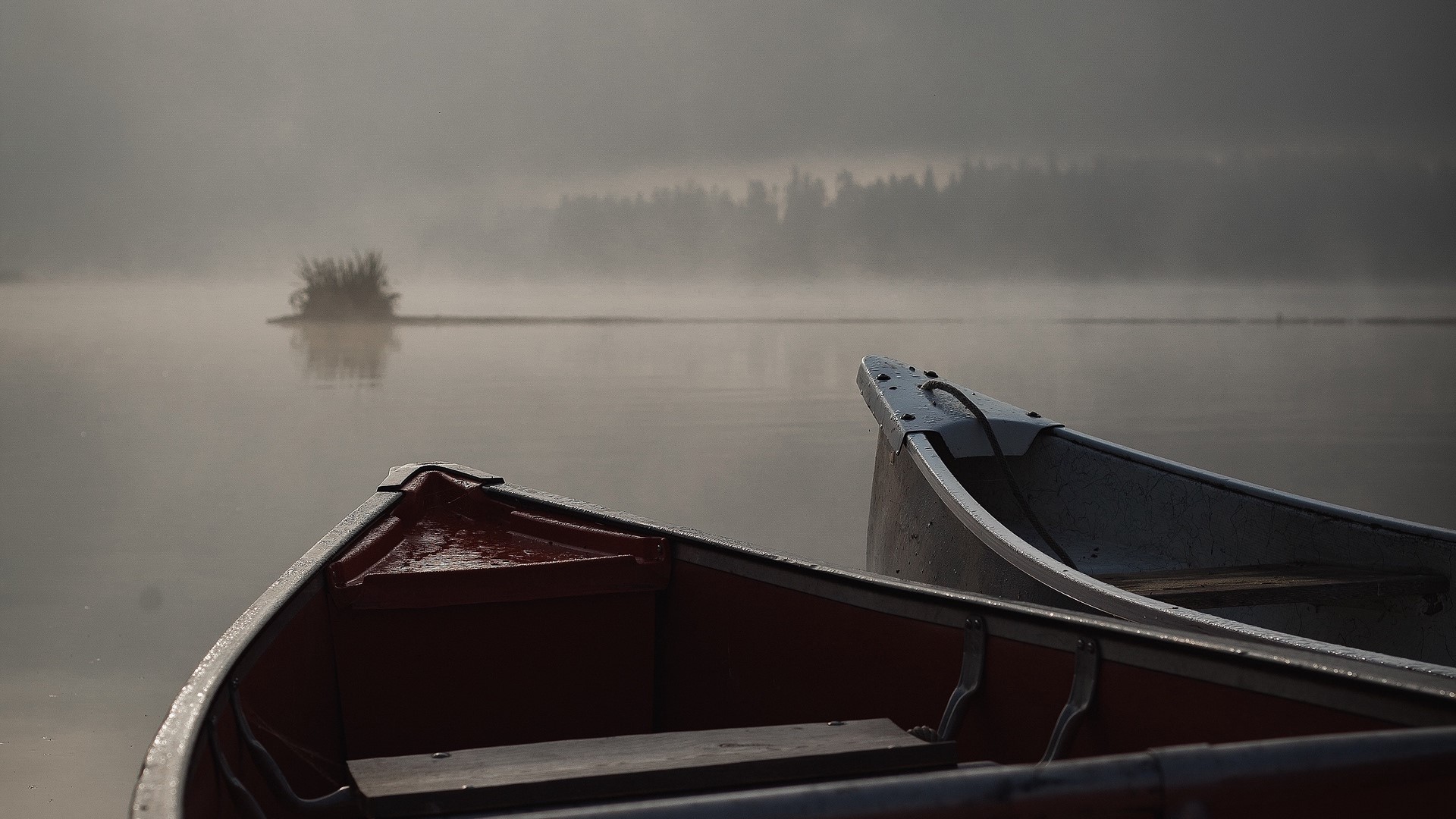 Two canoes on a misty lake at dawn HD Wallpaper