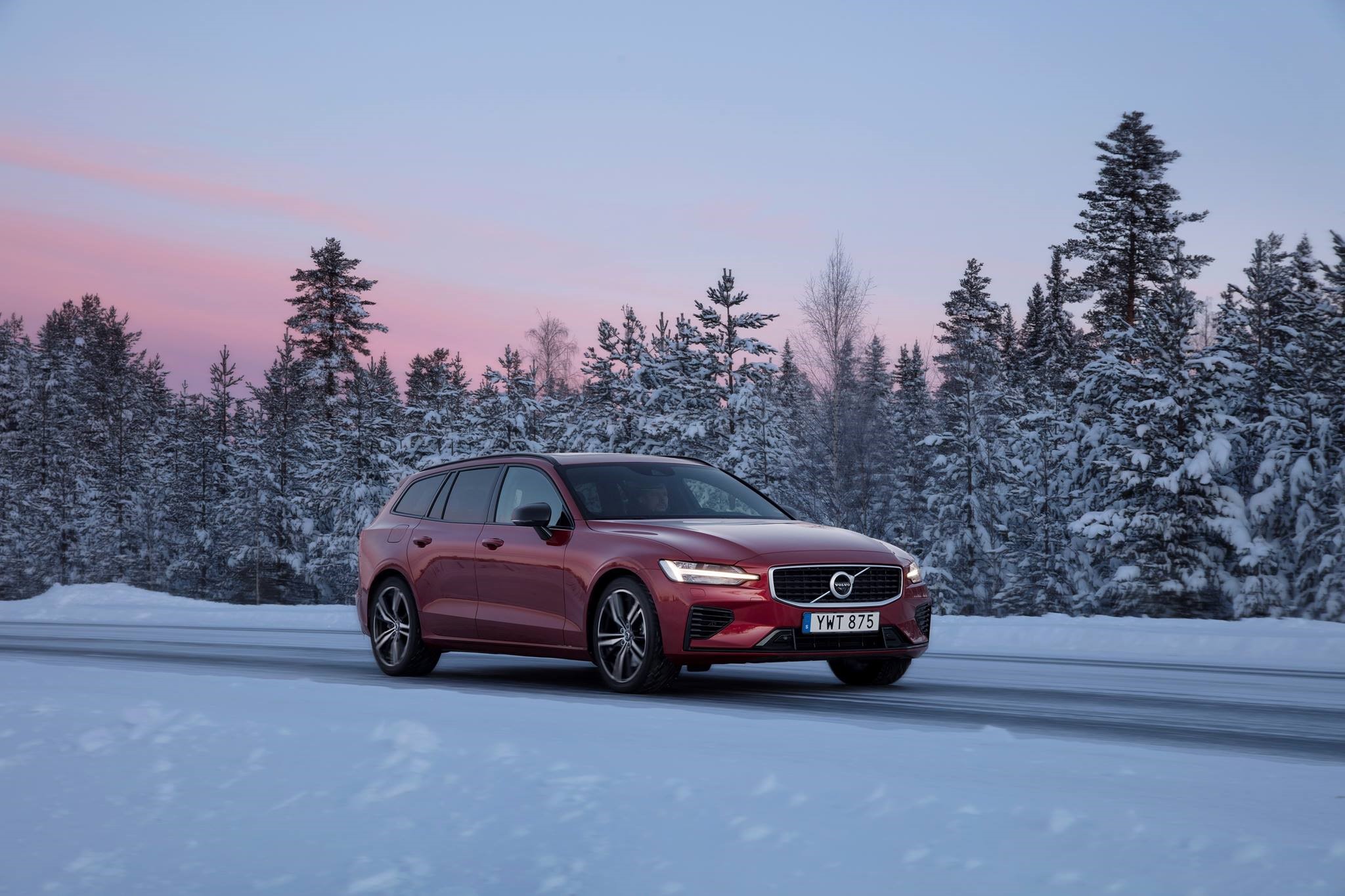 Red Volvo V90 CC driving on a snowy road HD Wallpaper