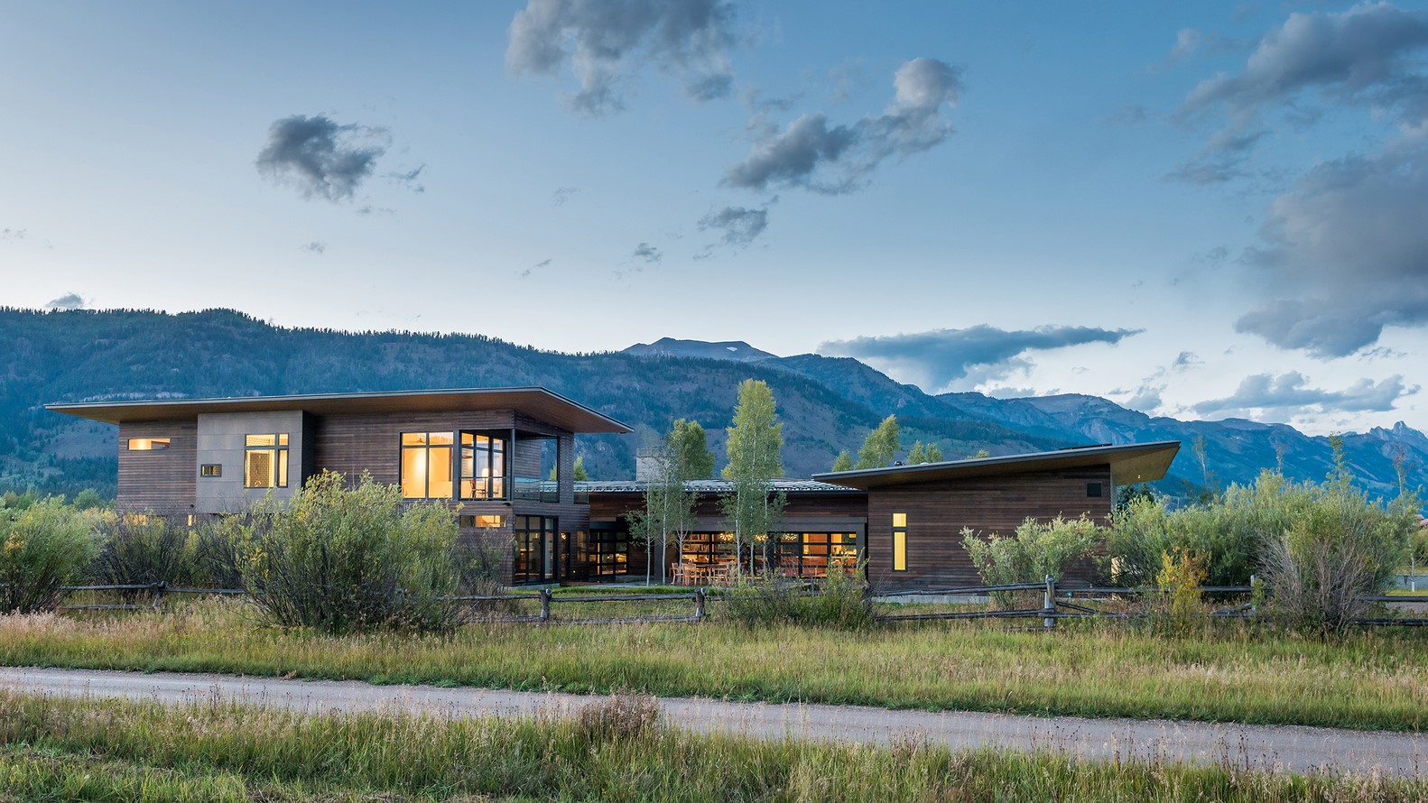 Modern house with wooden exterior and mountain backdrop HD Wallpaper