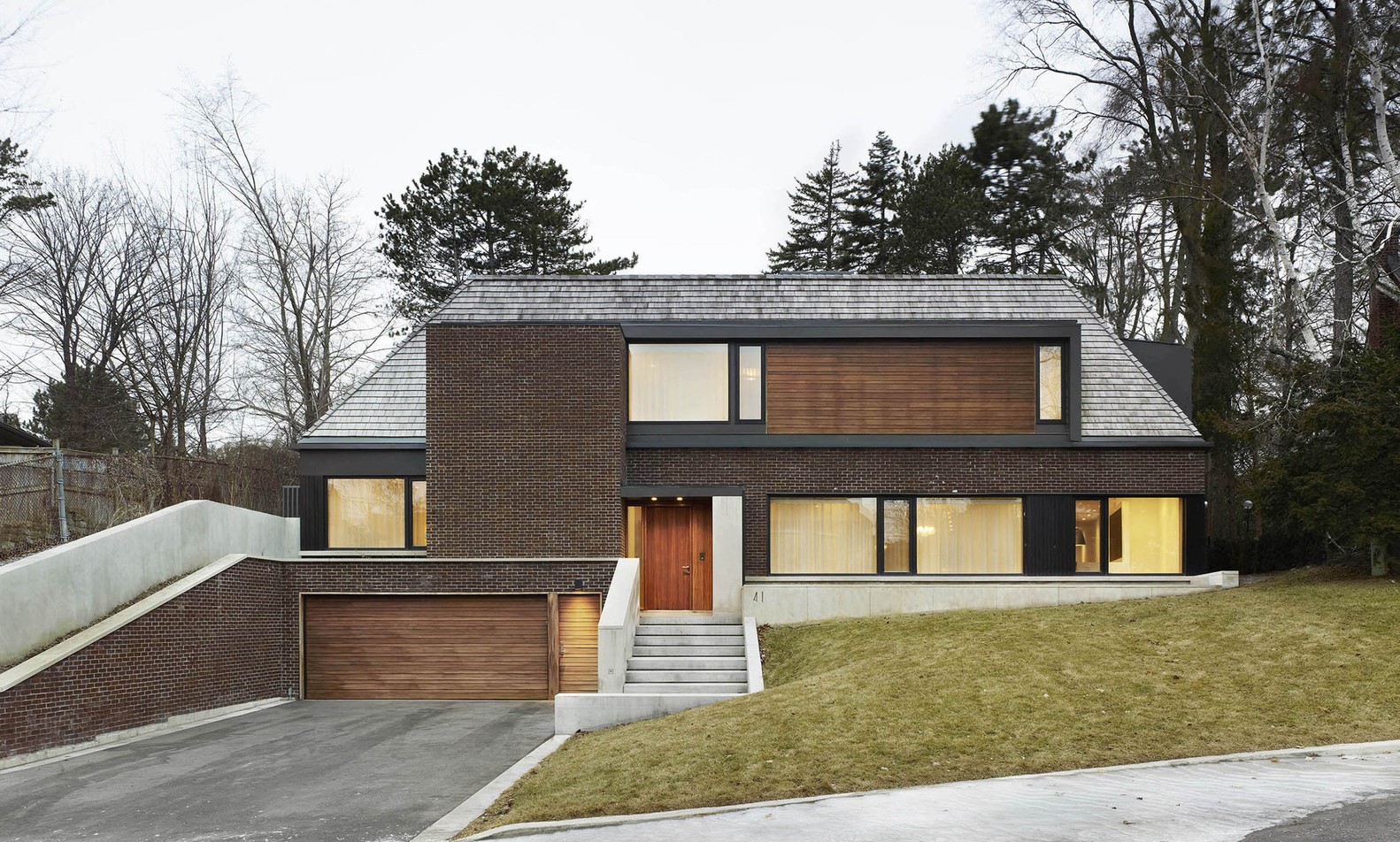 Modern brick house with garage and large windows HD Wallpaper