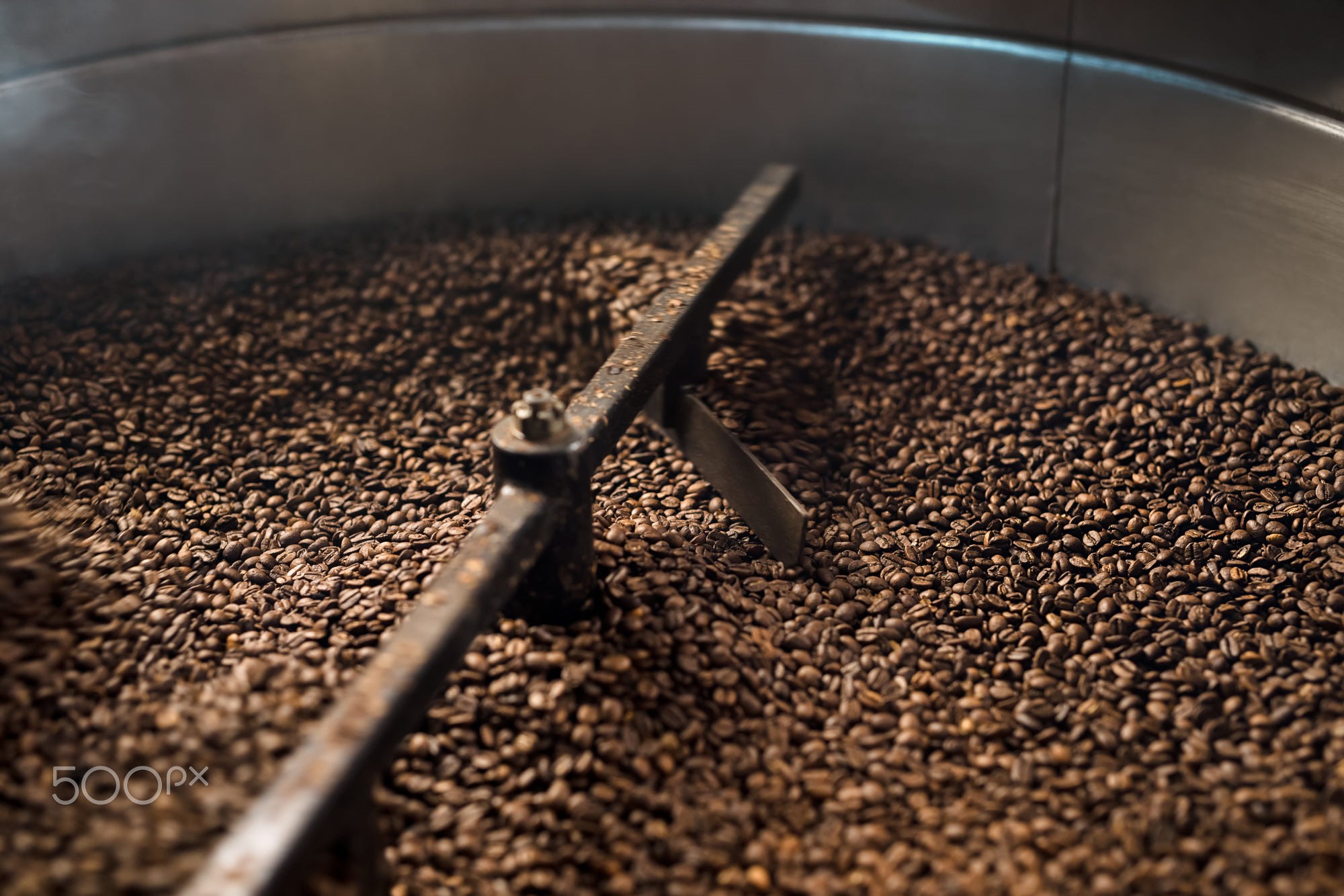 Coffee beans being roasted in a machine HD Wallpaper
