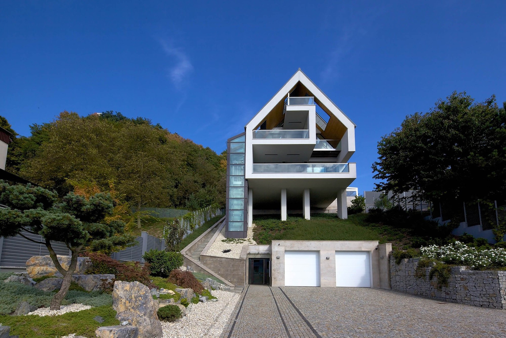 Modern house with balconies and garage on a hill HD Wallpaper