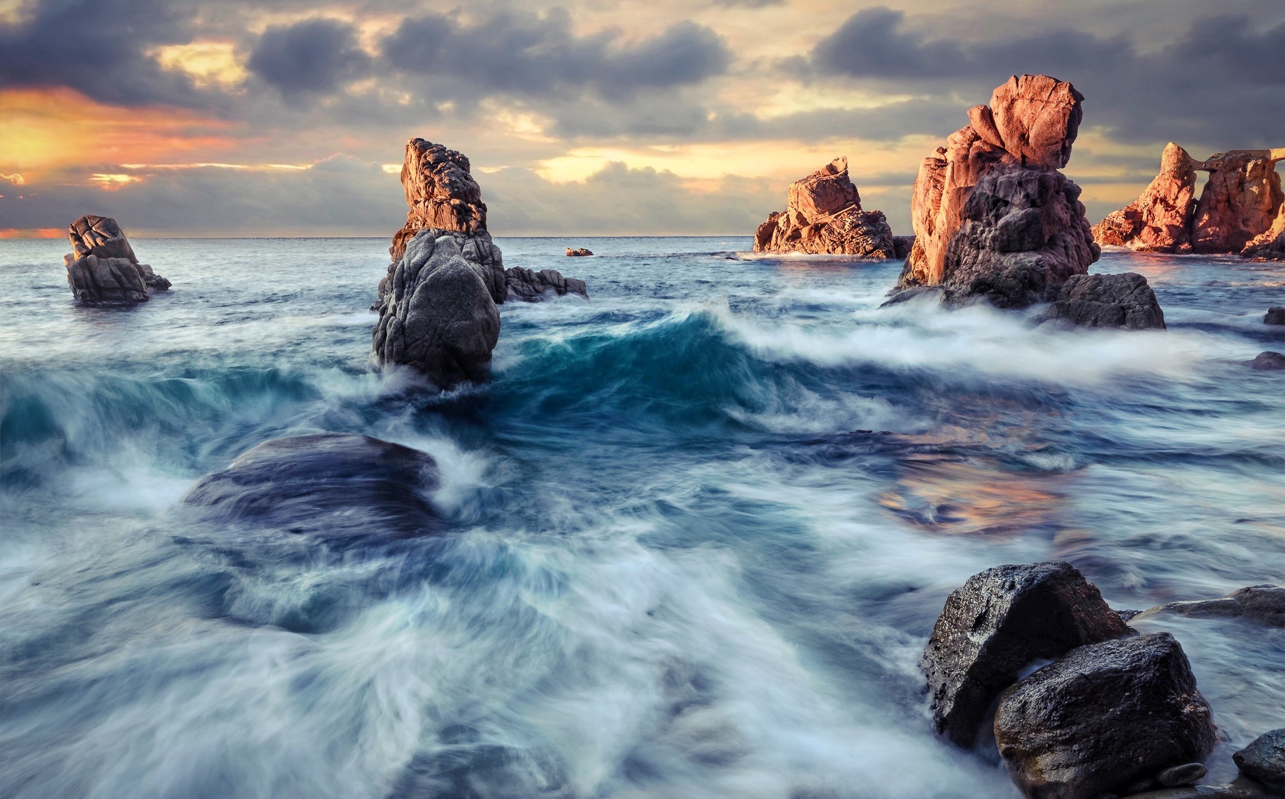 Rocky coastline with waves at sunset HD Wallpaper