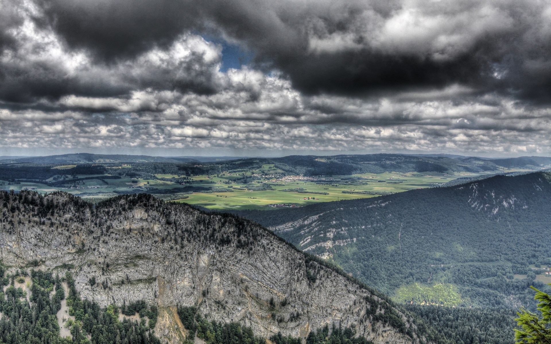 Overcast sky above rolling green hills and mountains HD Wallpaper