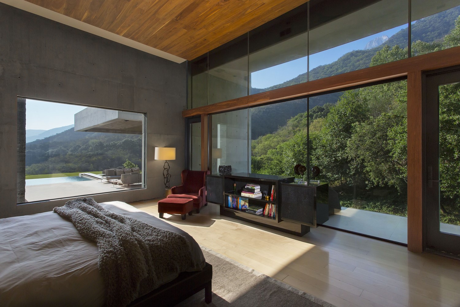 Modern bedroom with large windows overlooking a forest HD Wallpaper