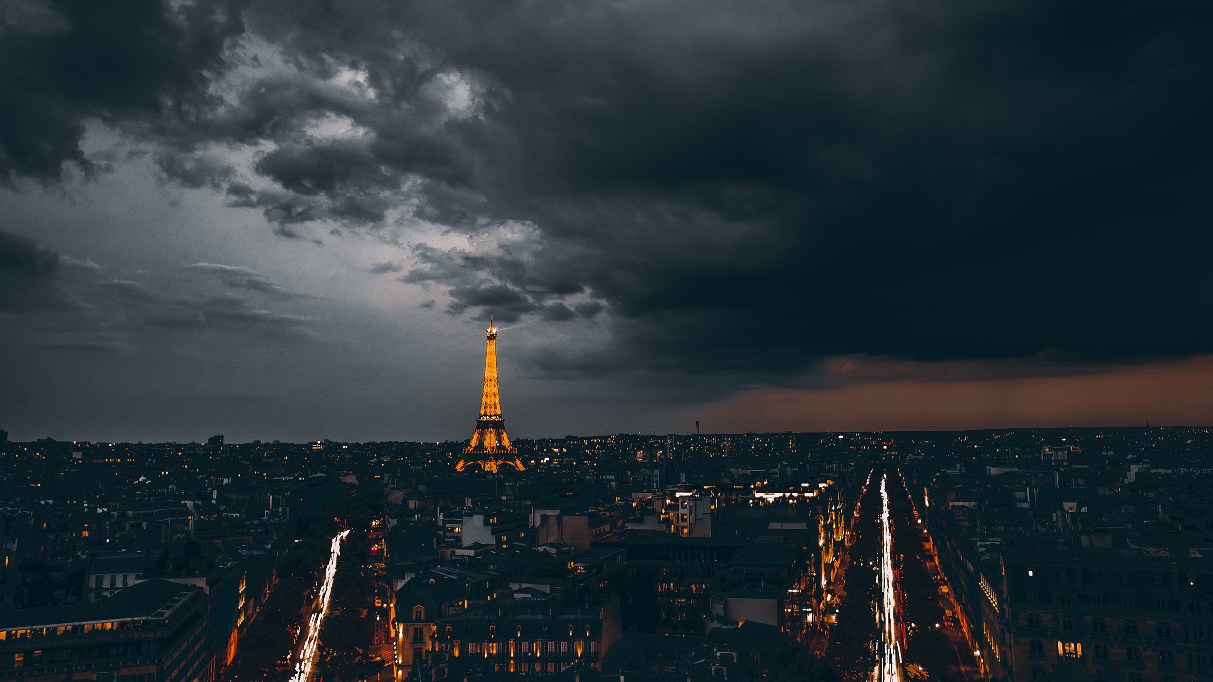 Eiffel Tower at night under stormy clouds HD Wallpaper