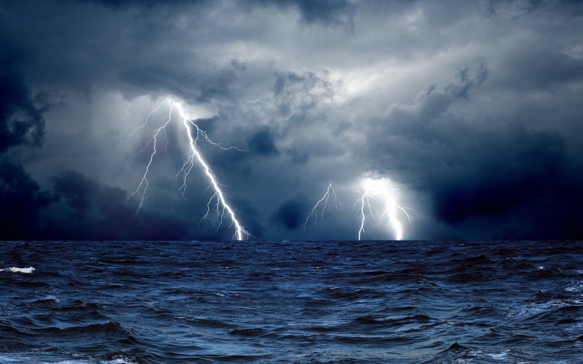 Lightning strikes over a stormy ocean HD Wallpaper