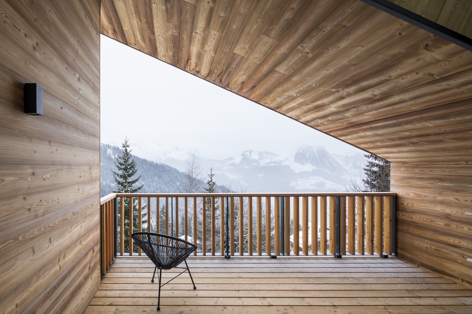 Wooden balcony overlooking snowy mountains in winter HD Wallpaper