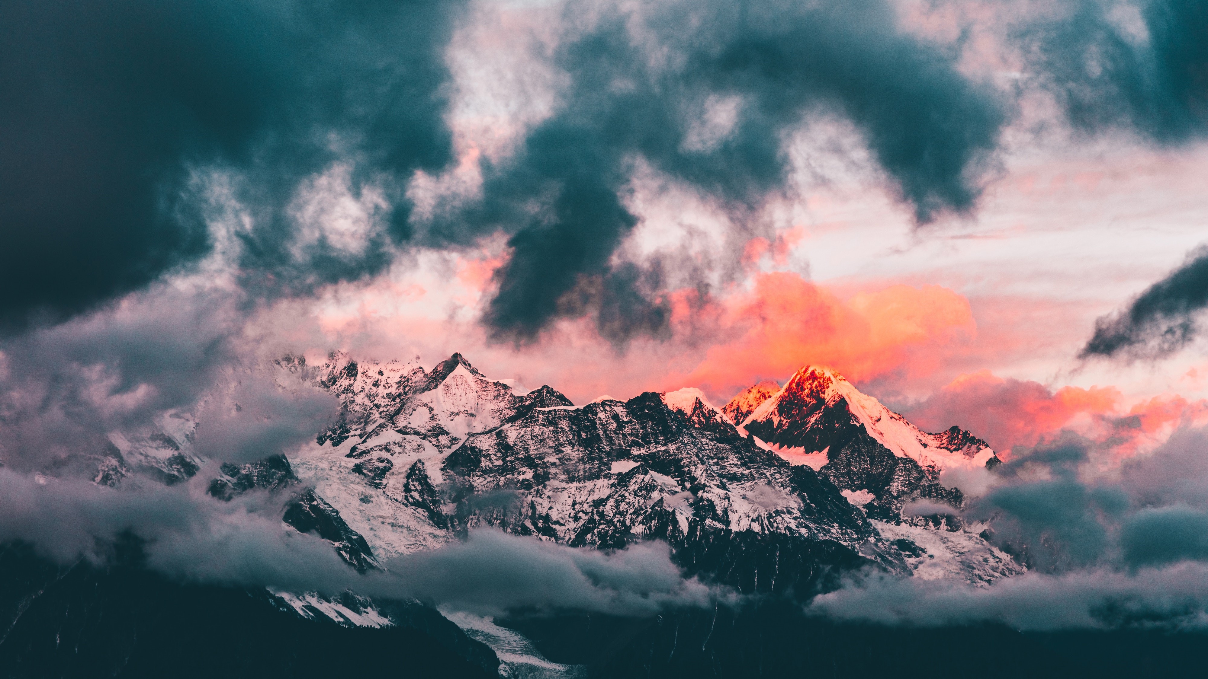 4K sunset over snow-capped mountains with clouds HD Wallpaper