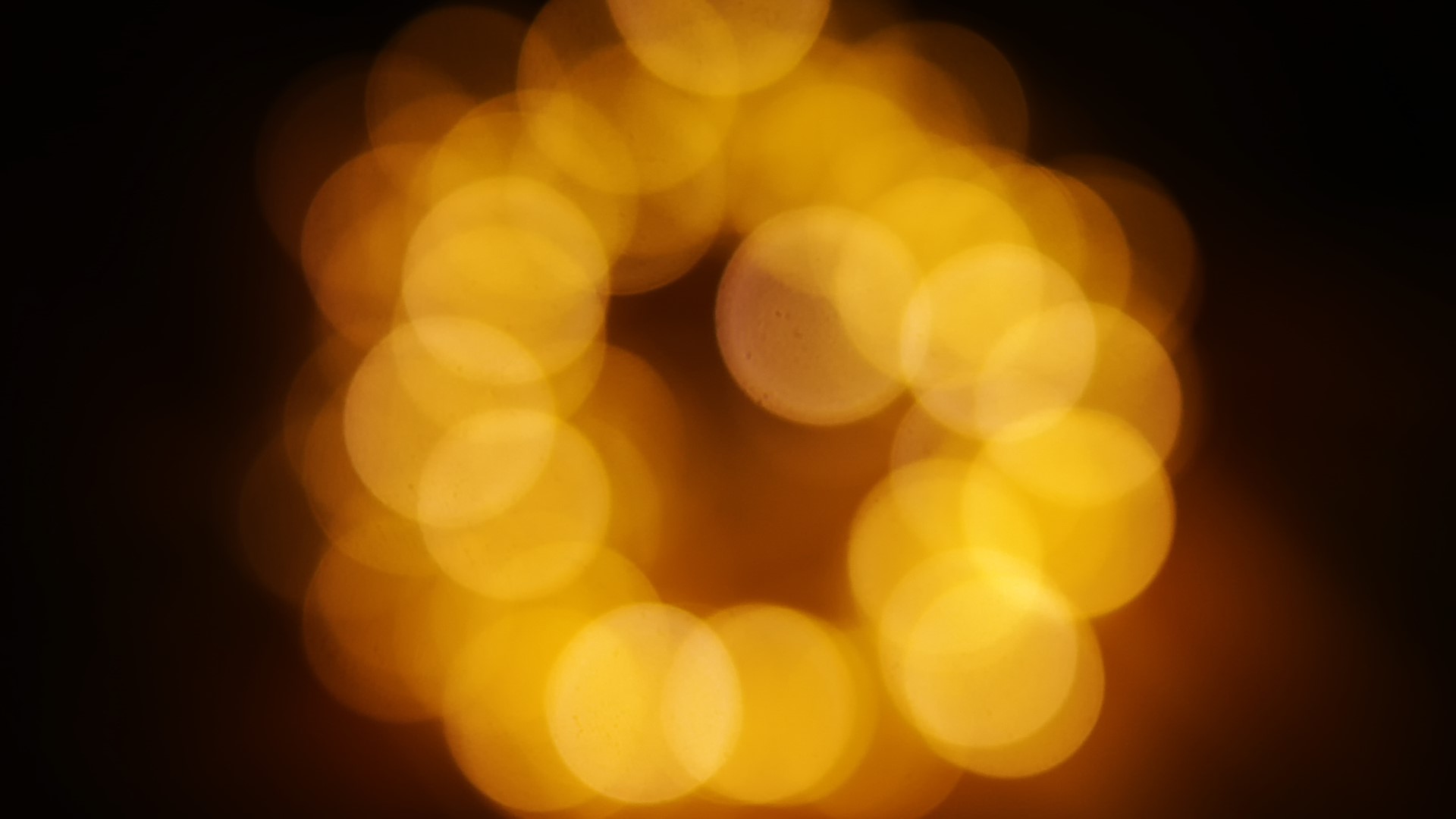 Abstract yellow bokeh circles on black background HD Wallpaper