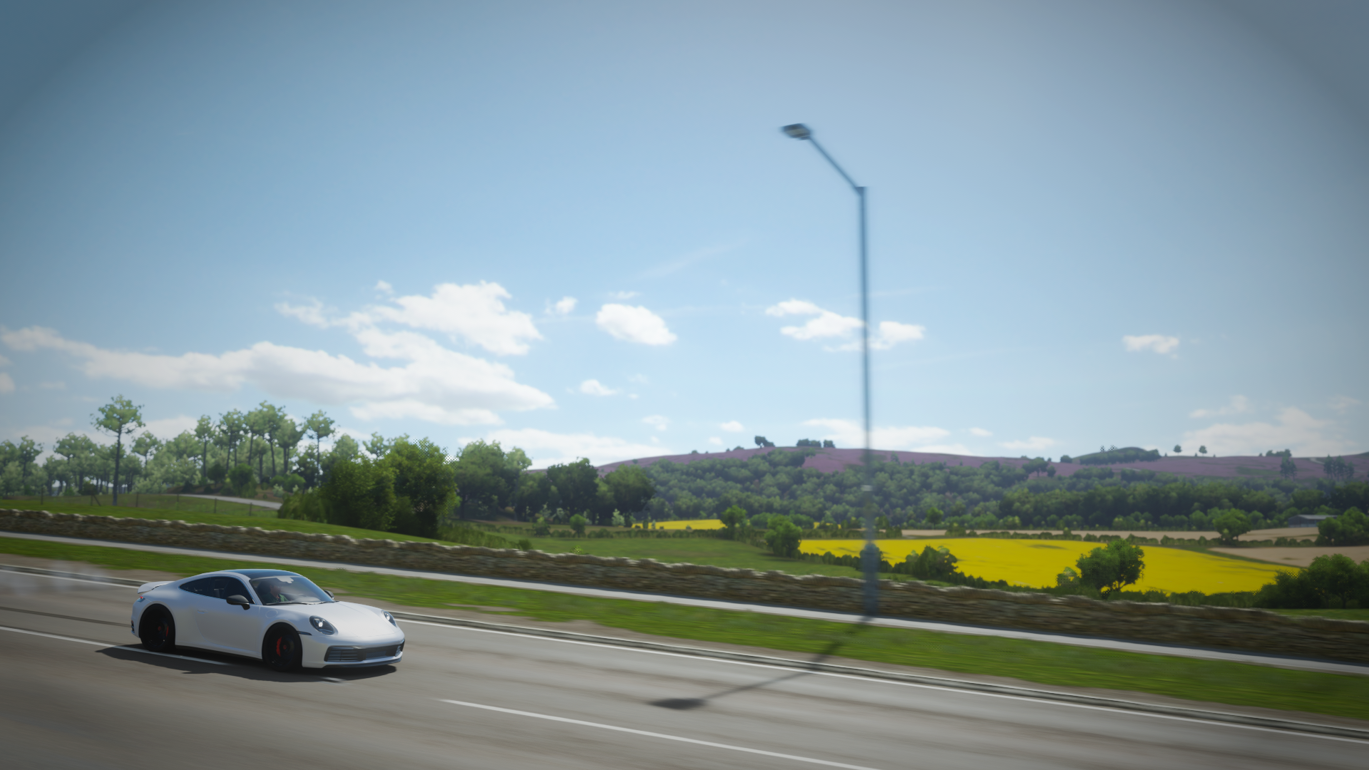 Porsche 911 driving on a road in Forza Horizon 4 HD Wallpaper