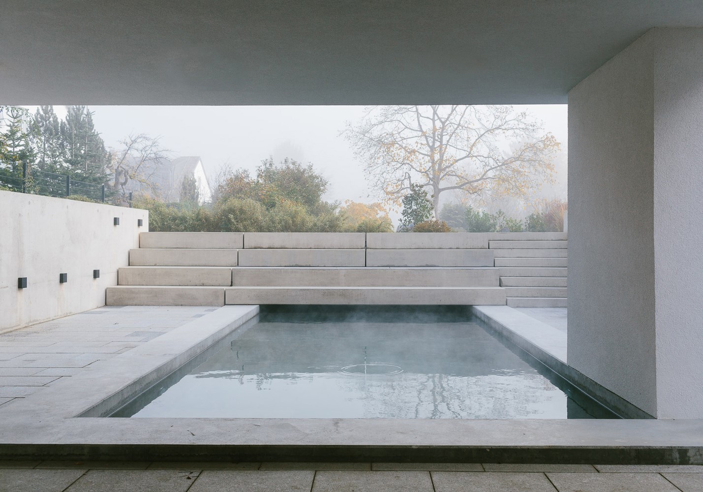 Modern outdoor spa with tiered concrete steps and pool HD Wallpaper