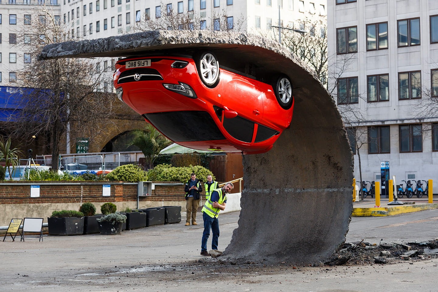 Red car sculpture by Alex Chinneck HD Wallpaper