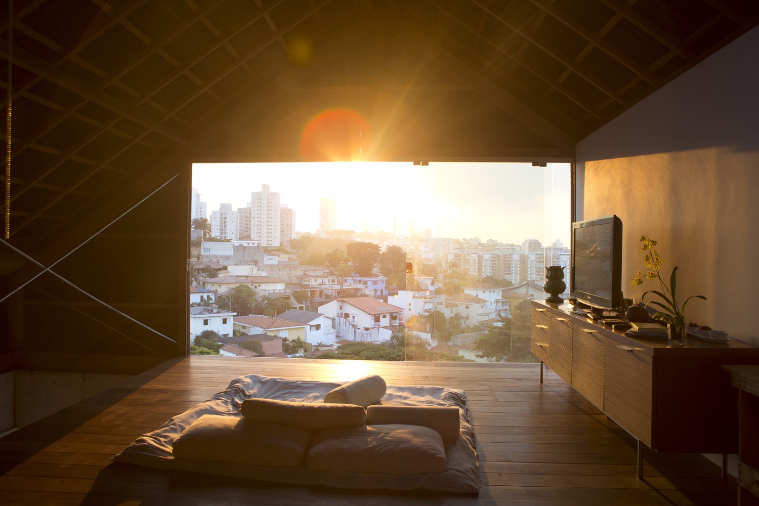 Interior view of a modern house with a city view at sunset HD Wallpaper