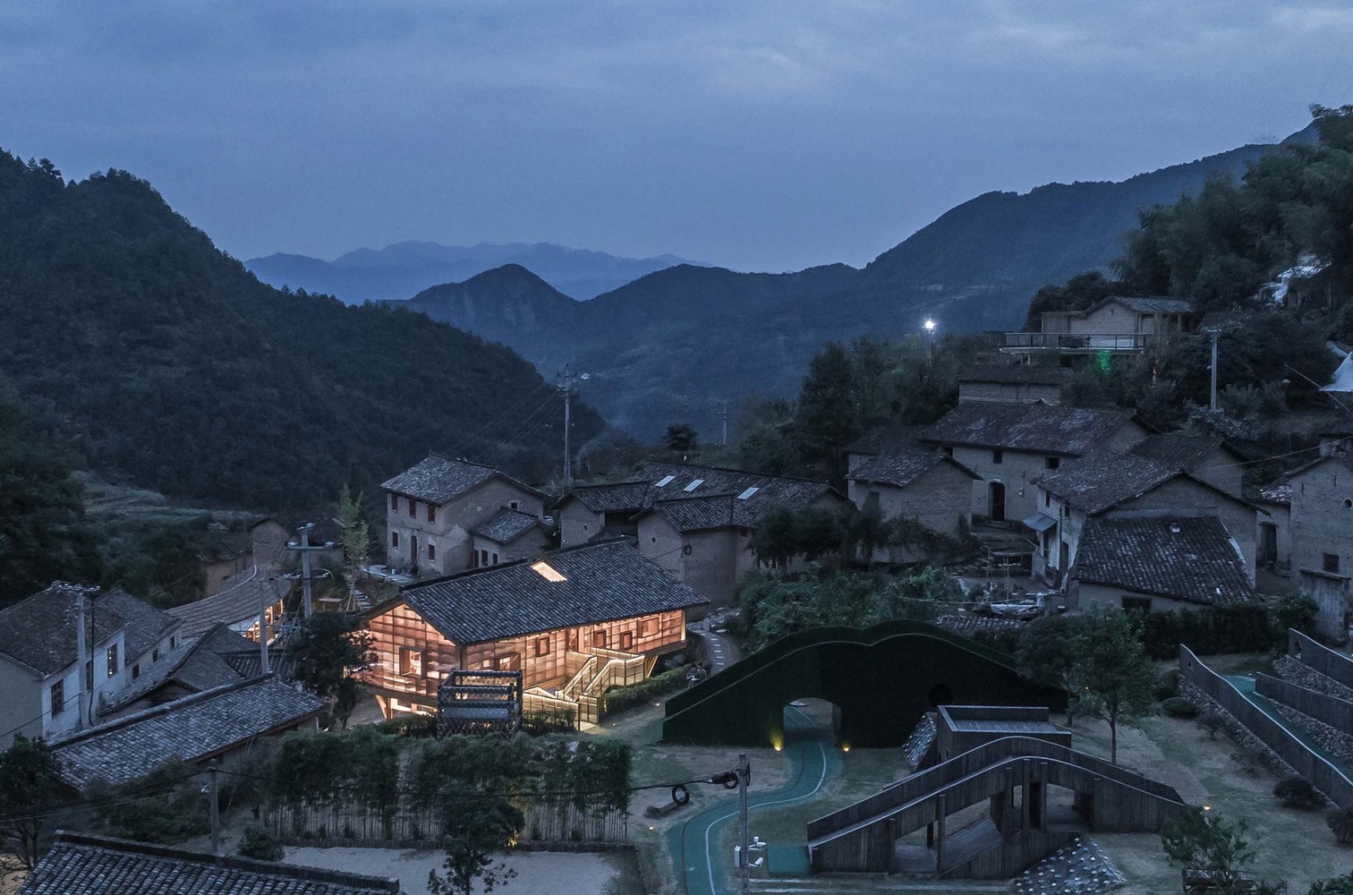 Village architecture in a mountainous landscape at dusk HD Wallpaper
