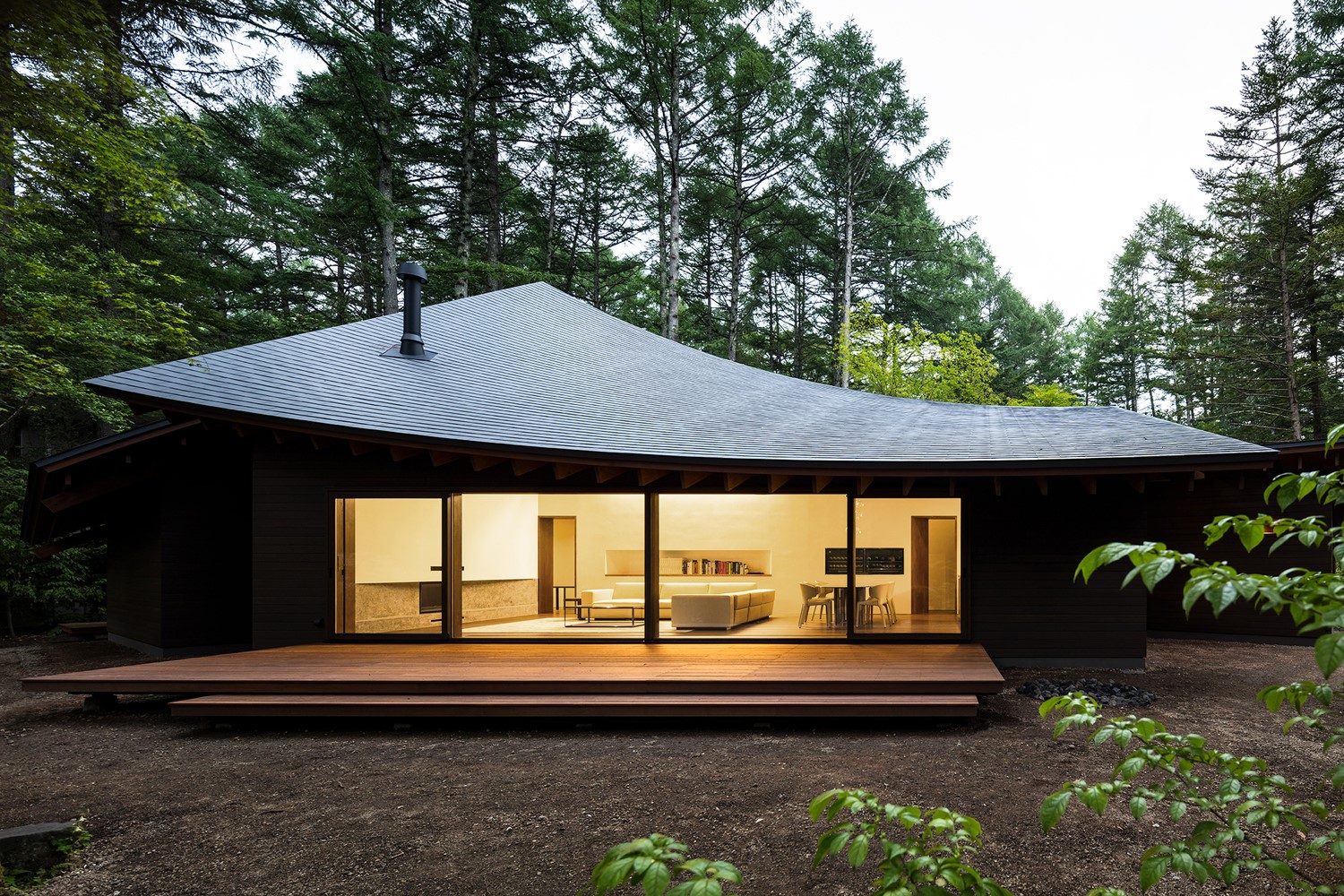 Modern house with curved roof in a forest HD Wallpaper