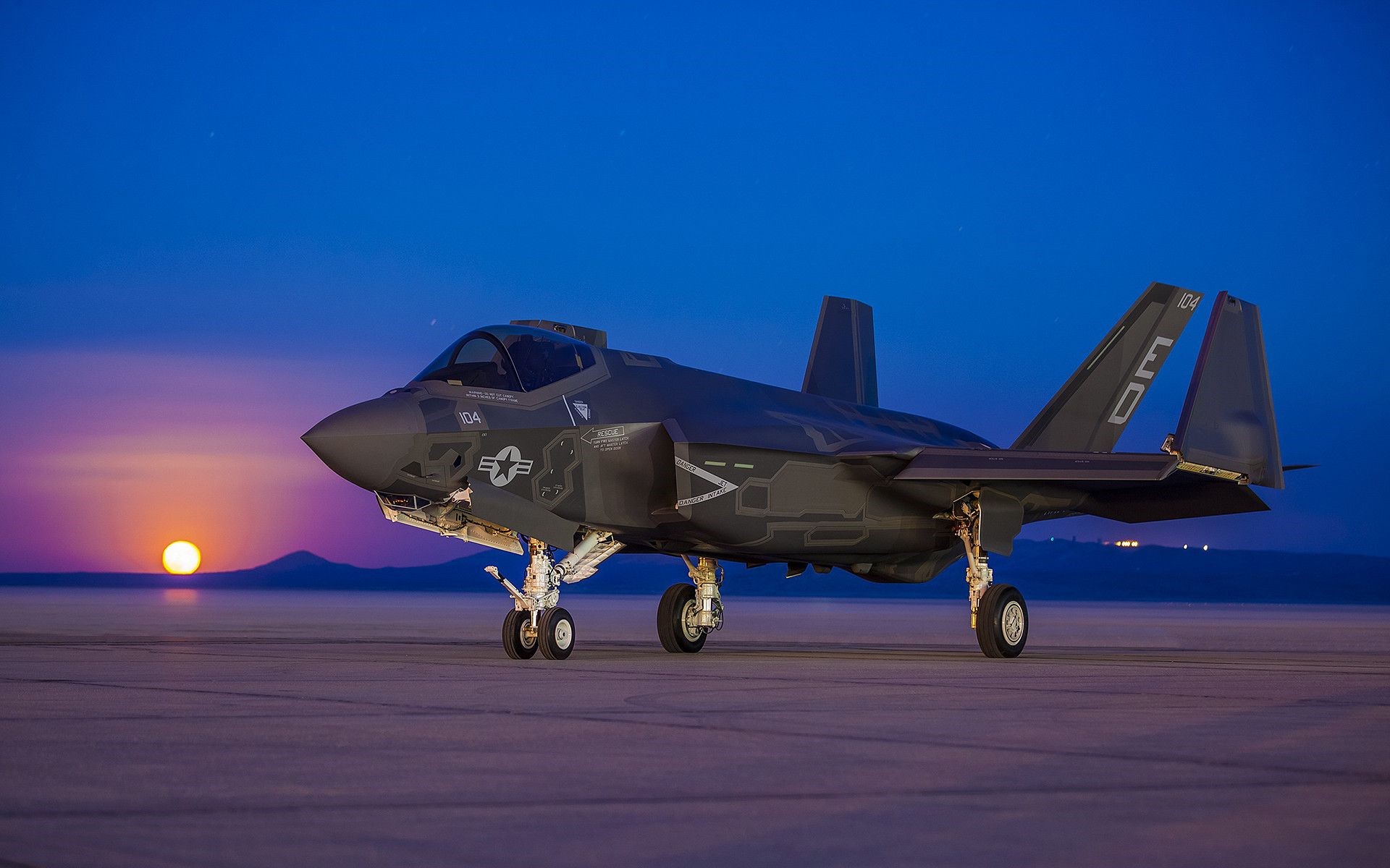 Lockheed Martin F-35 Lightning II on tarmac at sunset HD Wallpaper
