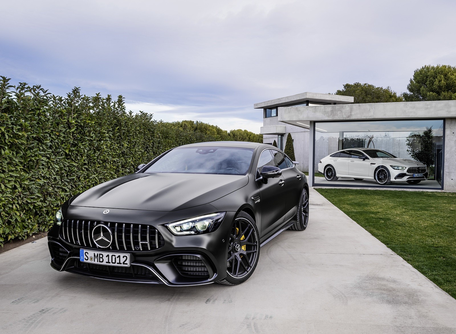 Mercedes-AMG GT 4-door cars in modern driveway HD Wallpaper