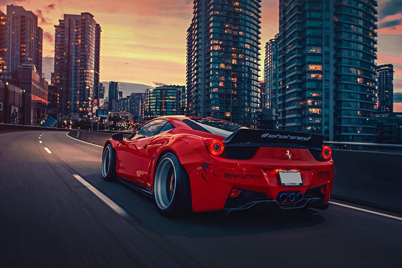 Red Ferrari 458 Italia driving in city at sunset HD Wallpaper