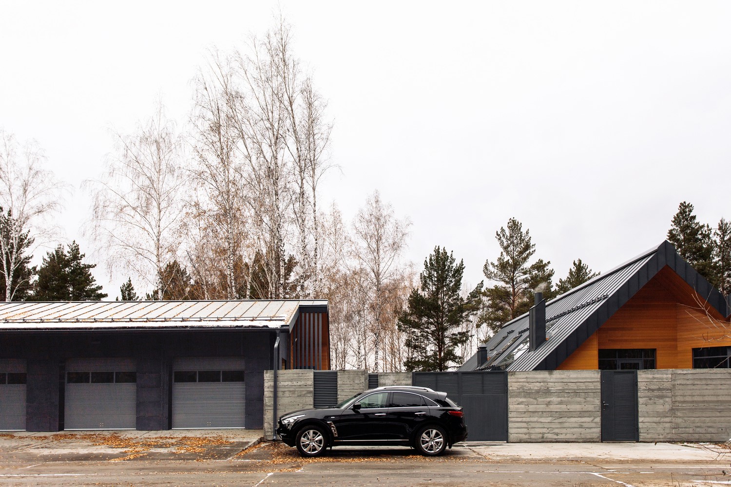 Modern garage and house with a black car HD Wallpaper