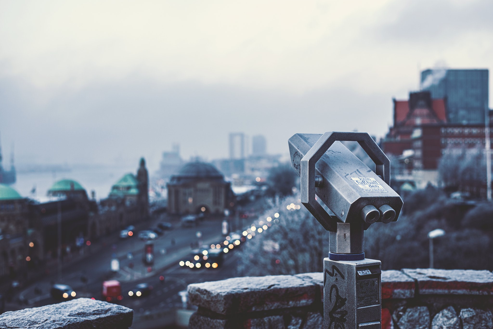 Binoculars overlooking a city with traffic HD Wallpaper