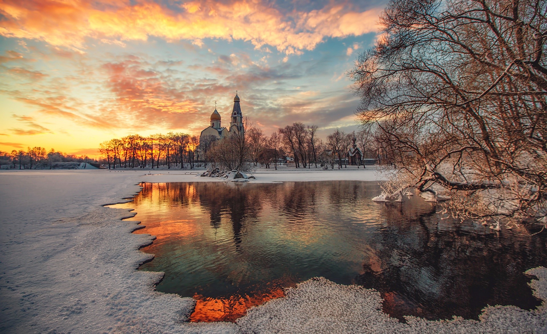 Winter sunset over a frozen lake with a church in Russia HD Wallpaper