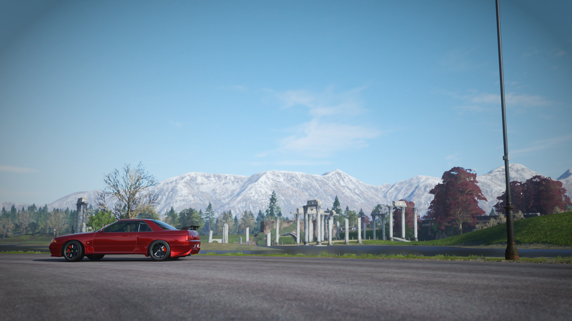 Red Nissan GTR R32 in front of snowy mountains HD Wallpaper
