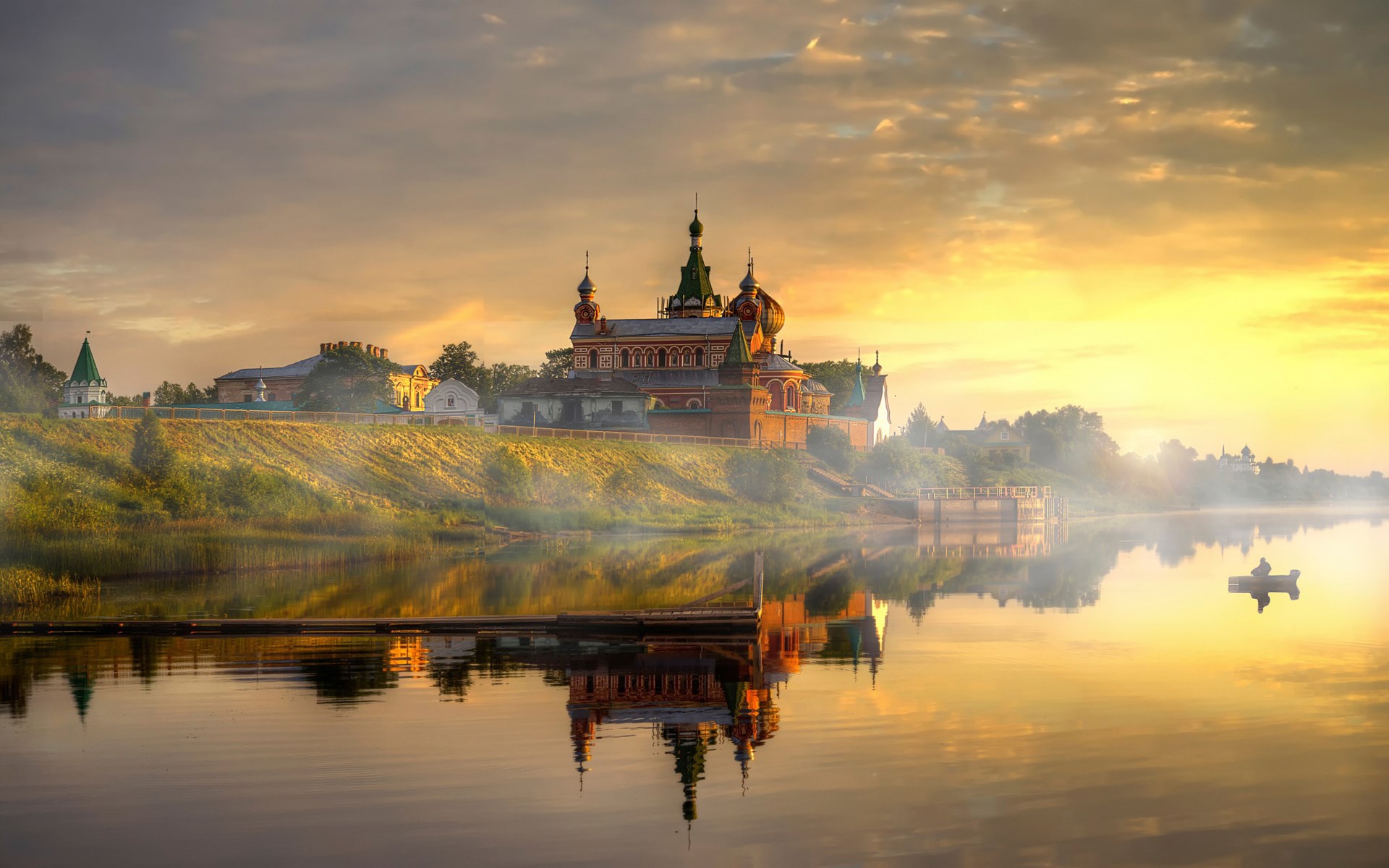 Monastery on a riverbank at sunrise with a boat HD Wallpaper