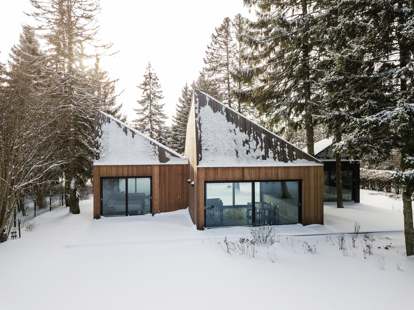 Modern wooden houses in a snowy forest HD Wallpaper