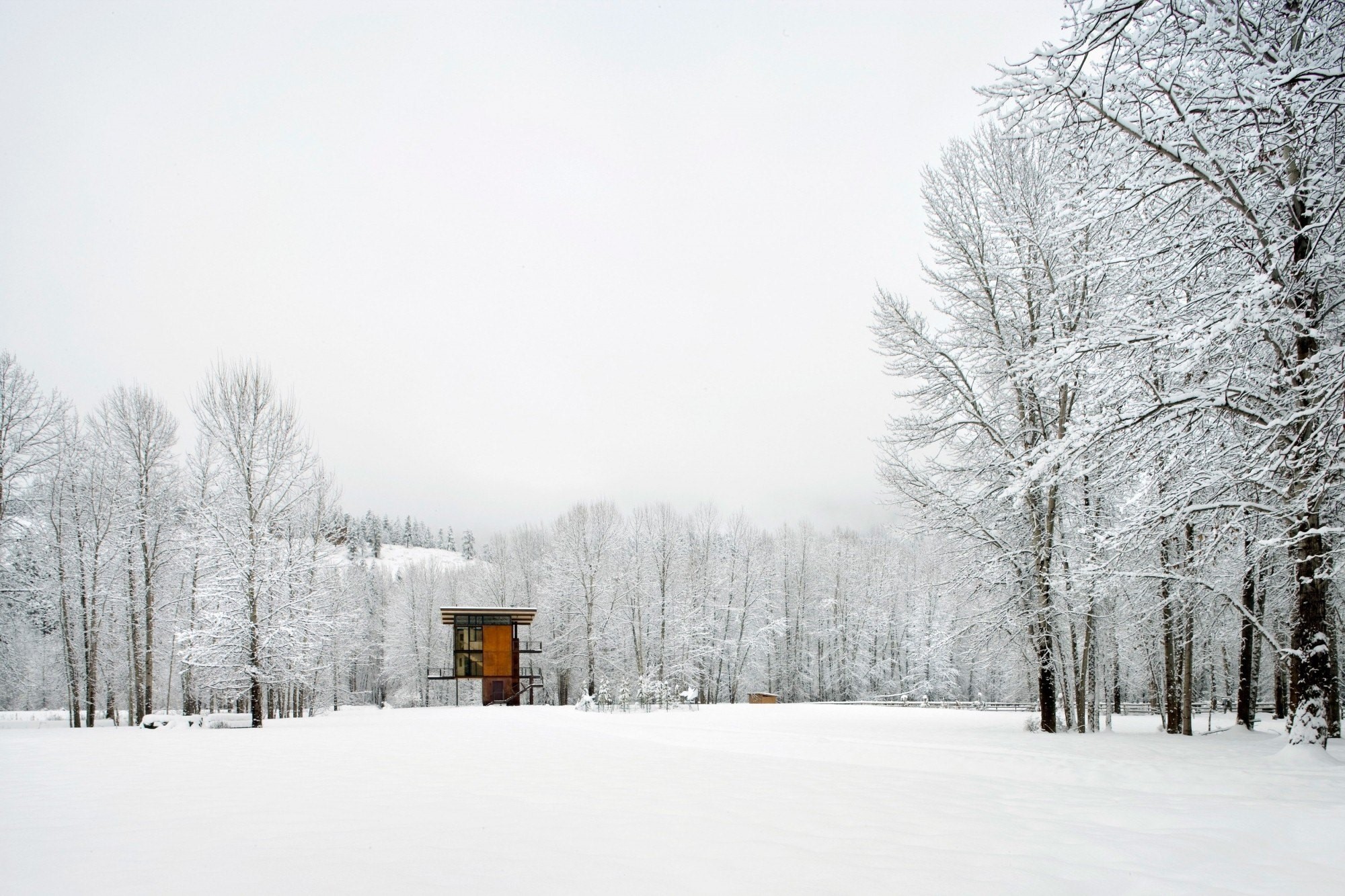 Modern house in a snowy landscape with mist HD Wallpaper