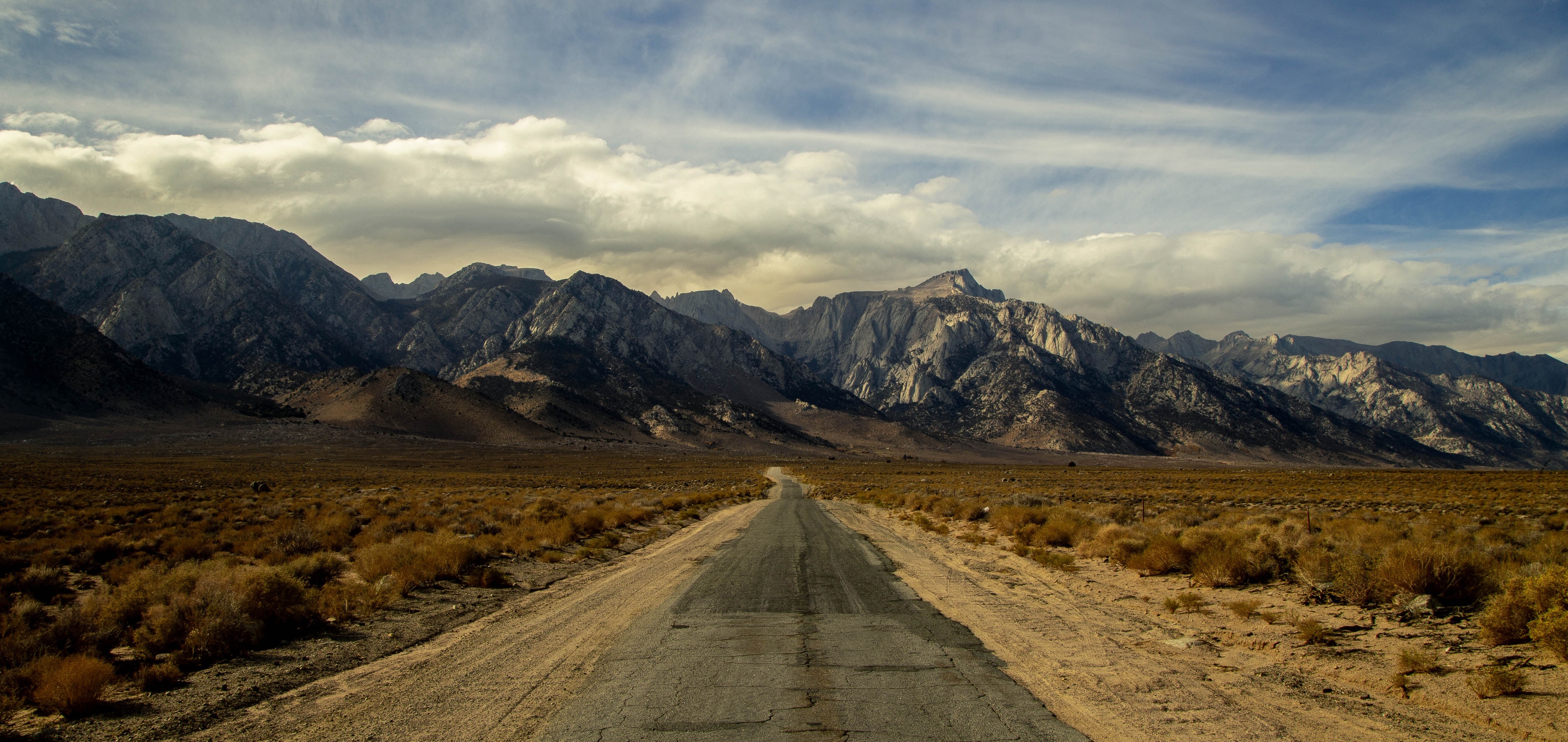 Road leading to mountains landscape HD Wallpaper