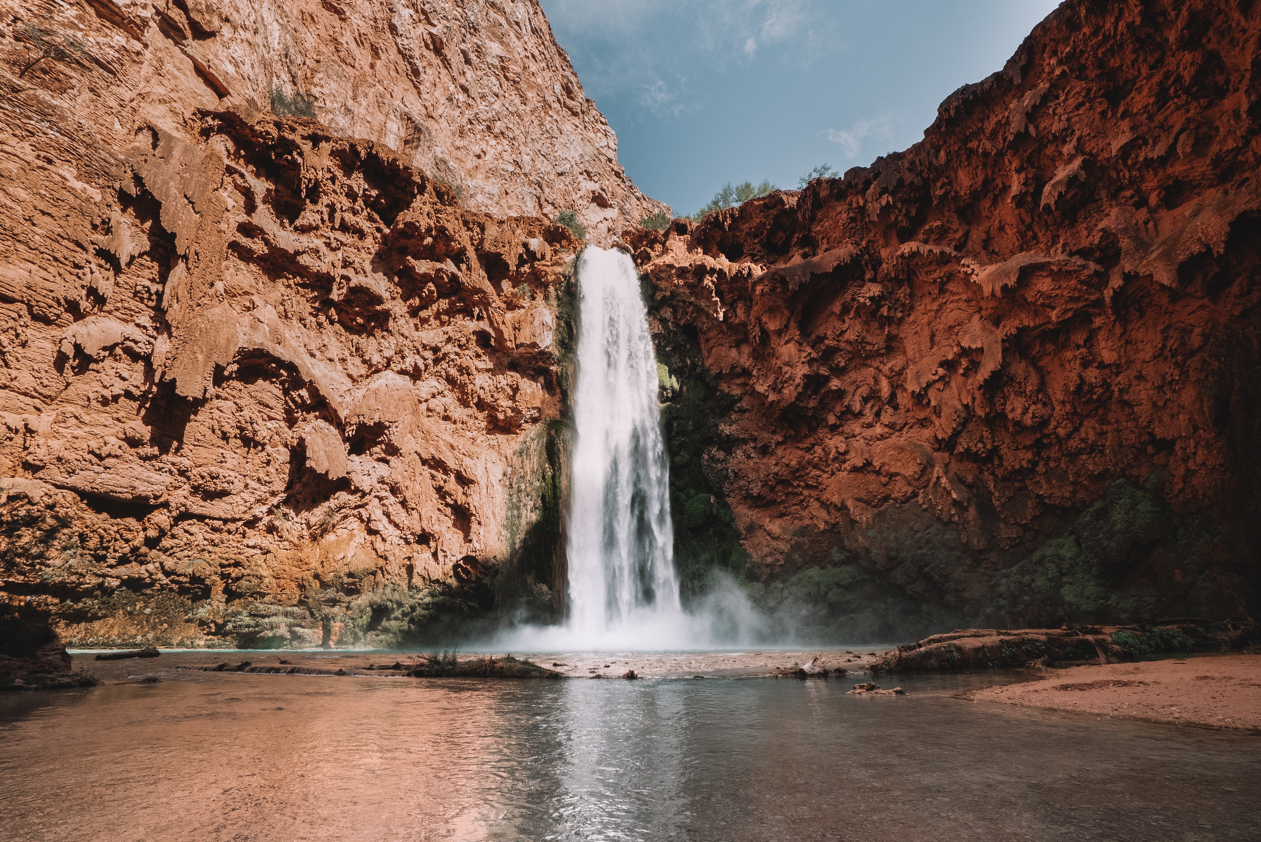 Waterfall in a canyon with red rocks HD Wallpaper