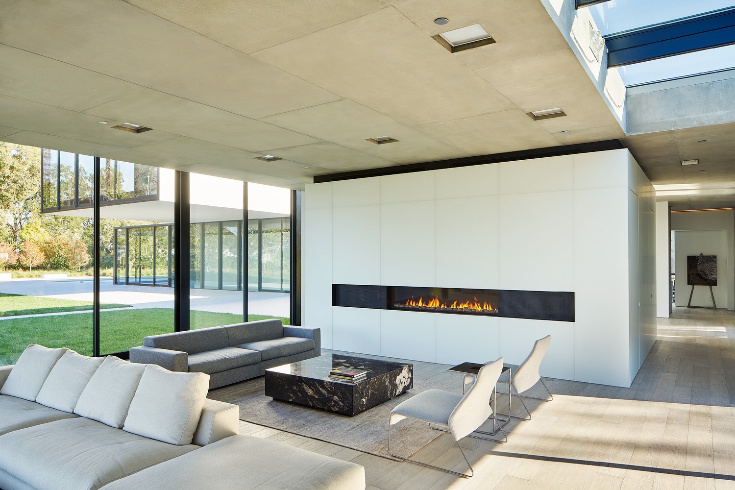 Modern living room with fireplace and large windows HD Wallpaper