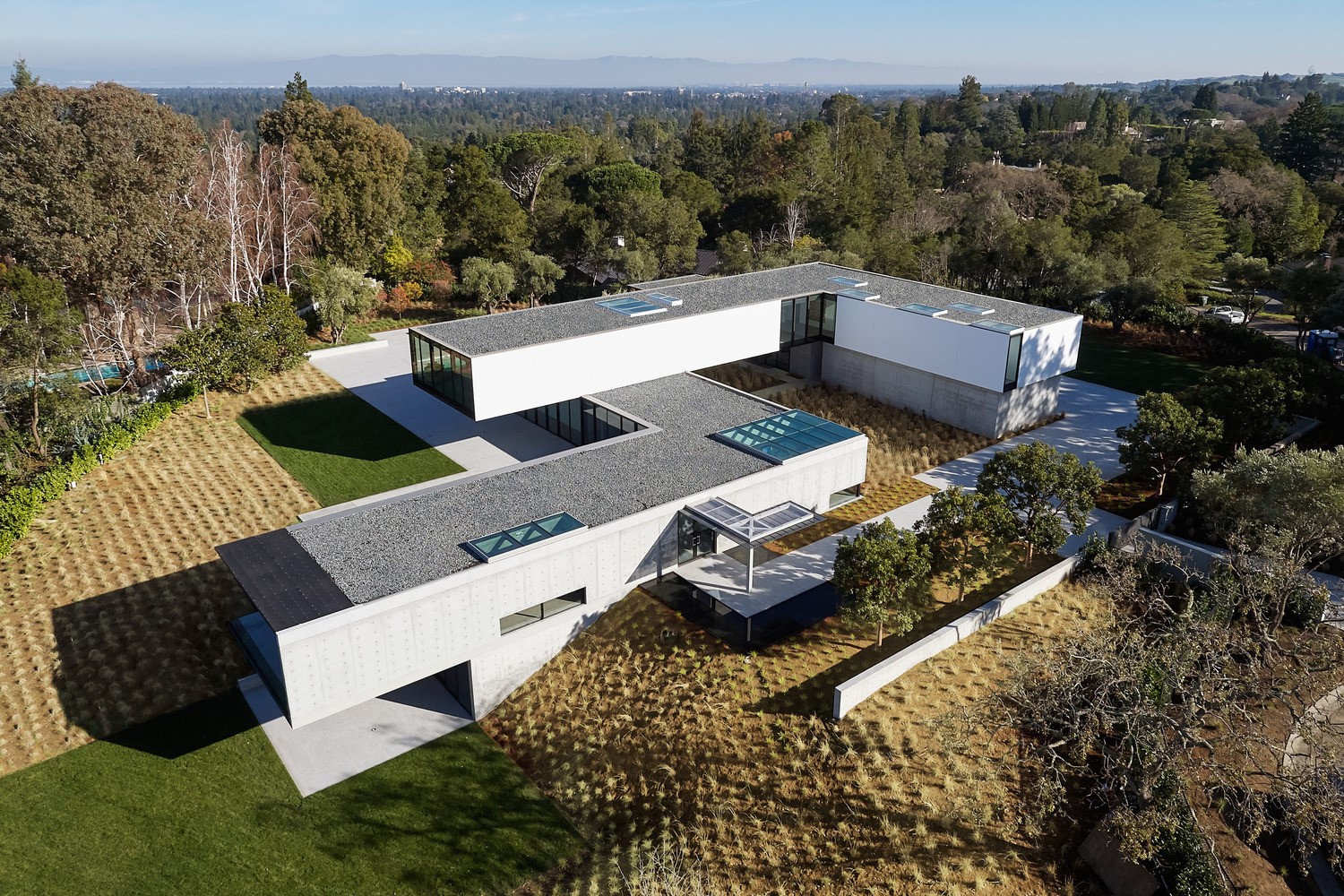 Modern concrete and white house with glass skylights HD Wallpaper