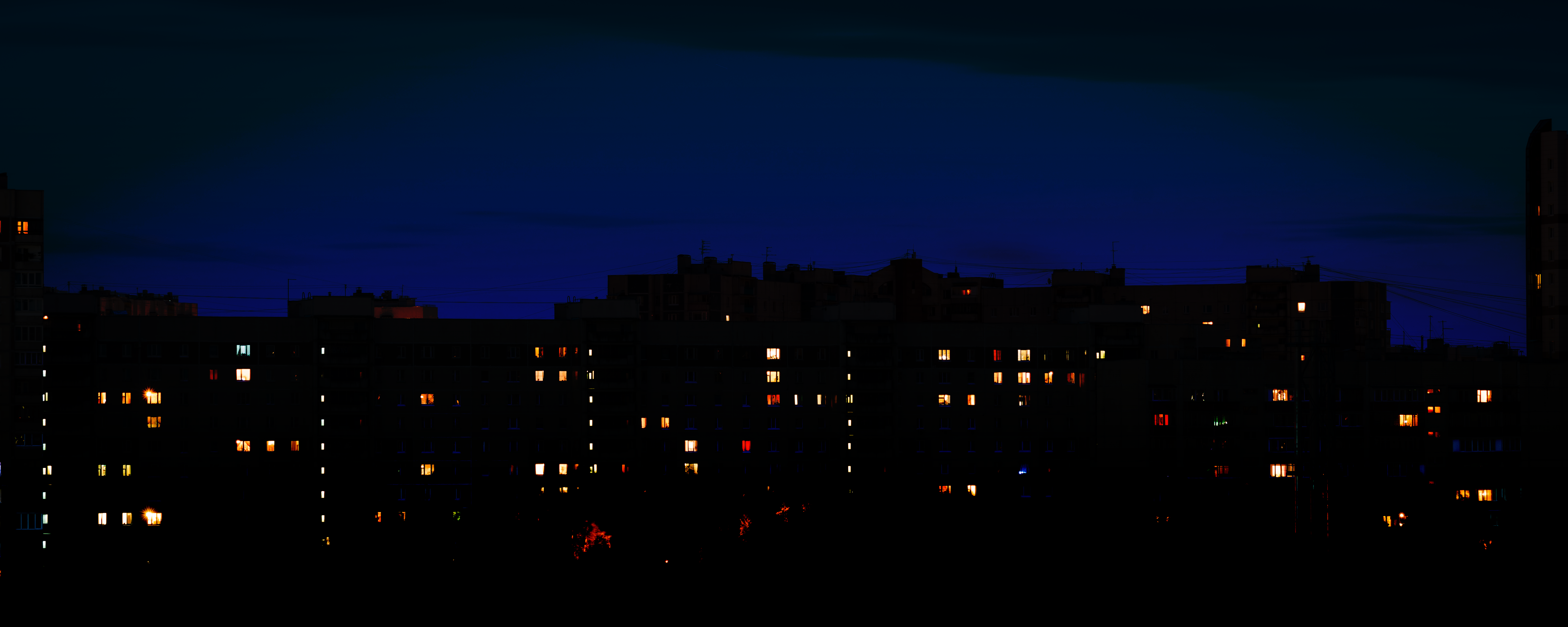 Apartment buildings at night with illuminated windows HD Wallpaper