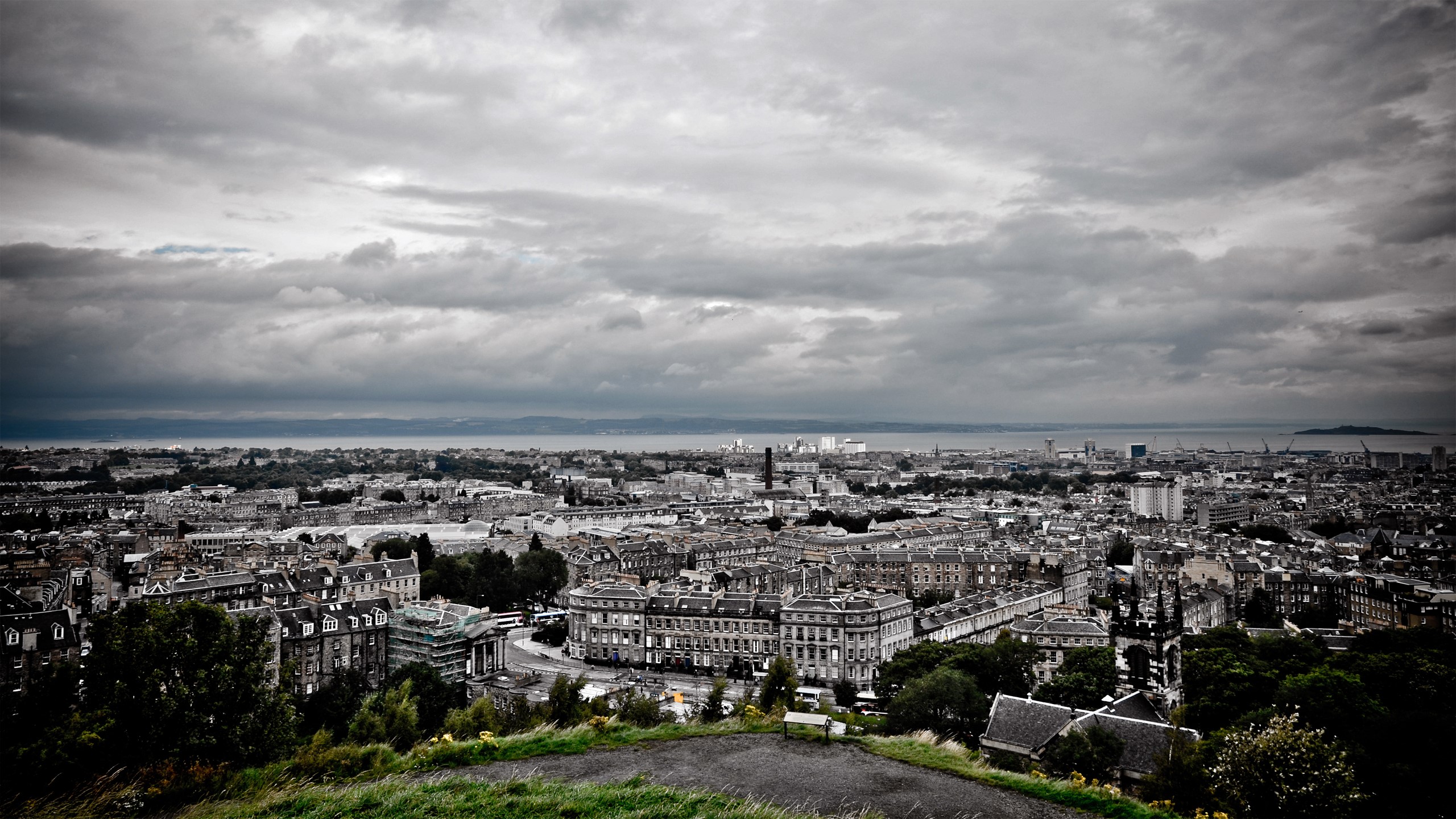 Cityscape with dramatic clouds over buildings and water HD Wallpaper