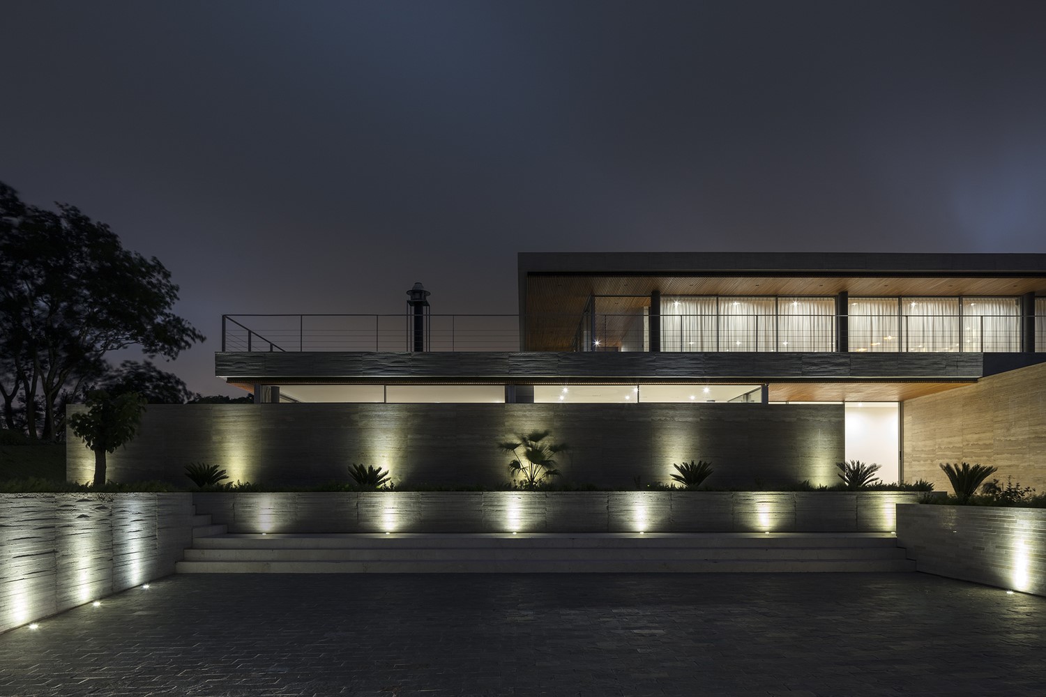 Modern mansion with exterior lighting at night HD Wallpaper