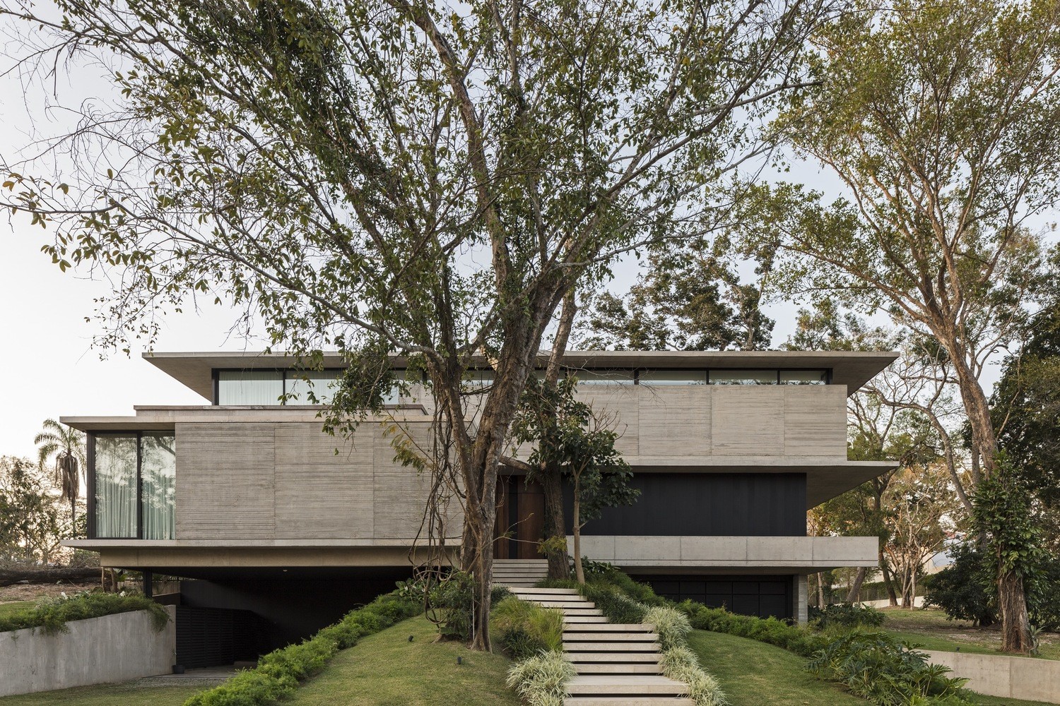 Modern concrete house with large trees HD Wallpaper