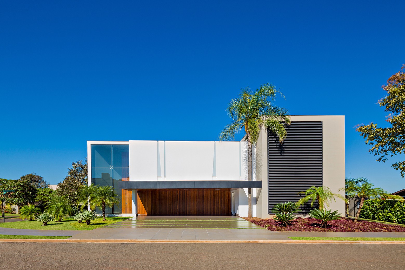 Modern mansion with large wooden doors and glass windows HD Wallpaper