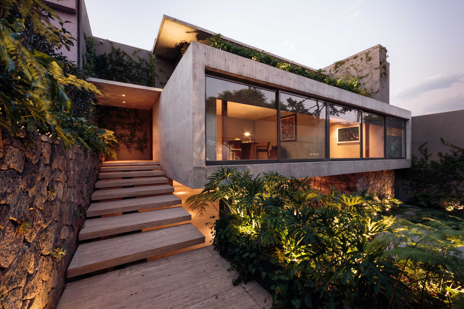 Modern concrete house with stone wall and stairs HD Wallpaper