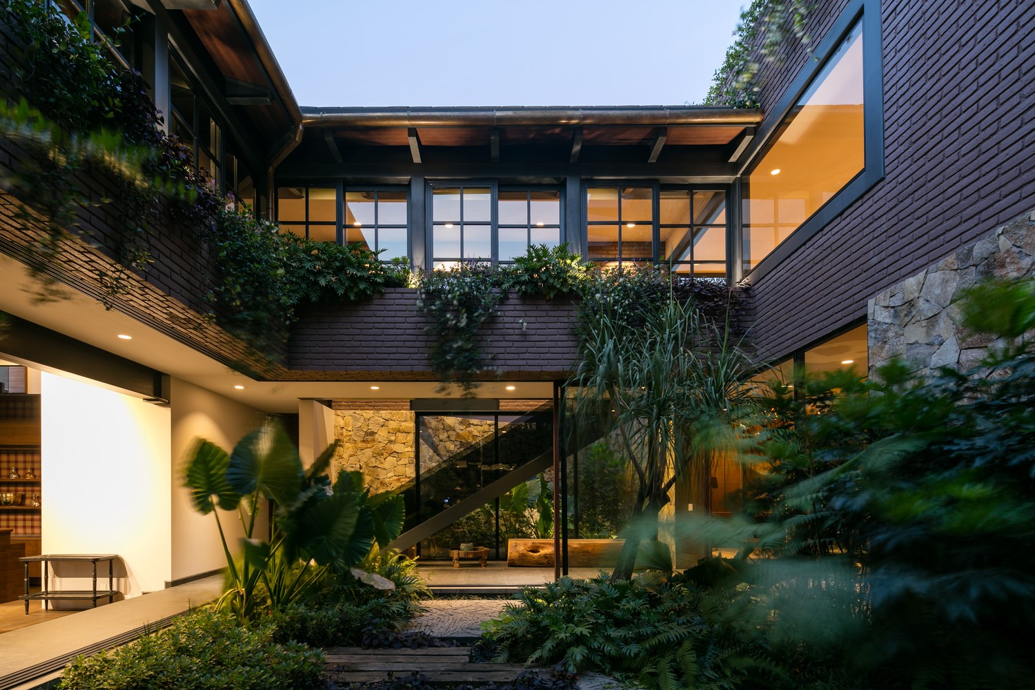 Modern house with plants and stone walls HD Wallpaper