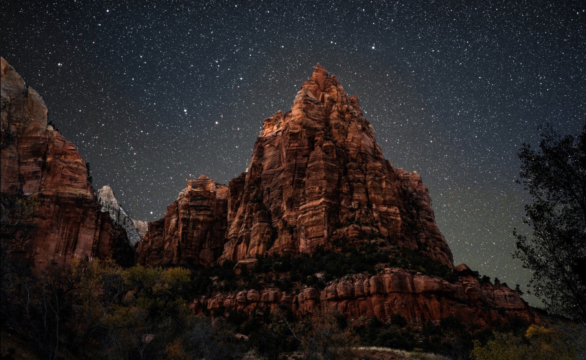 Mountain peak under a starry night sky HD Wallpaper