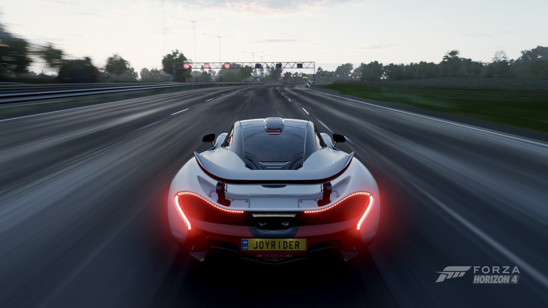 McLaren P1 driving on a highway in Forza Horizon 4 HD Wallpaper