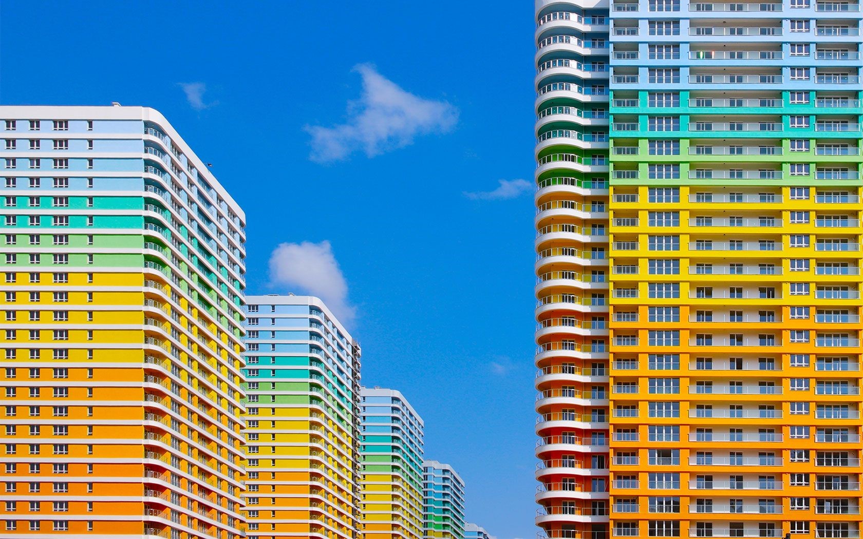 Colorful apartment buildings against a blue sky HD Wallpaper